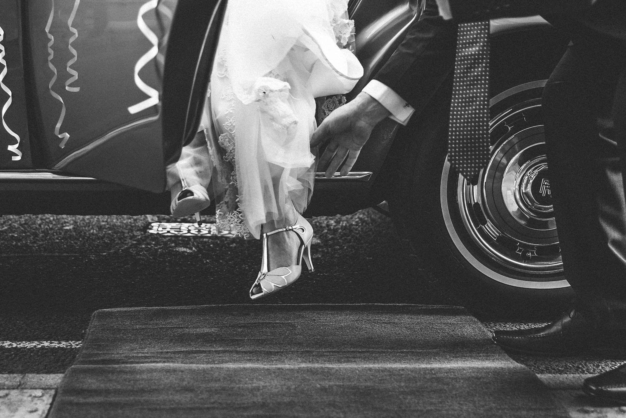 Bride stepping out of wedding car