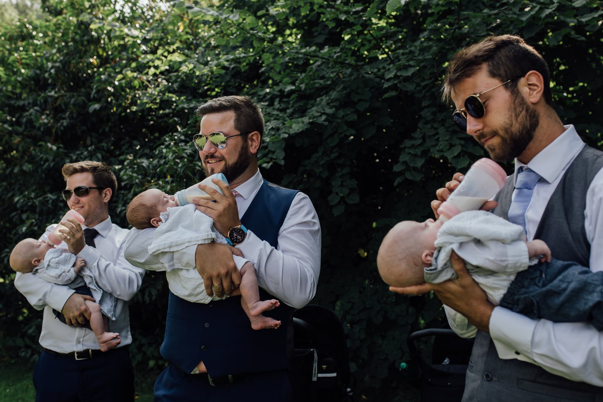 wedding guests feeding triplets during ceremony