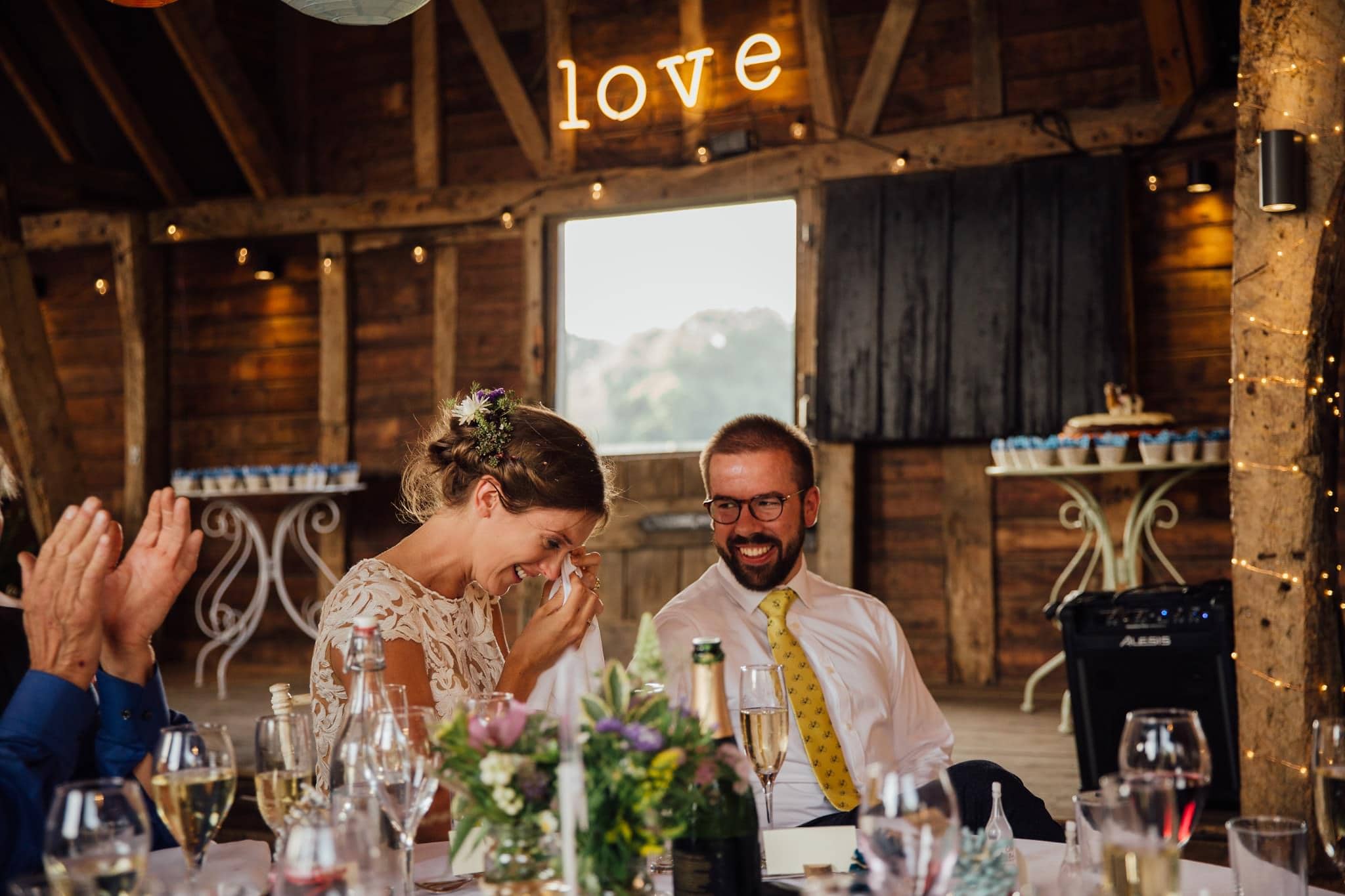 bride crying during speeches at barn wedding