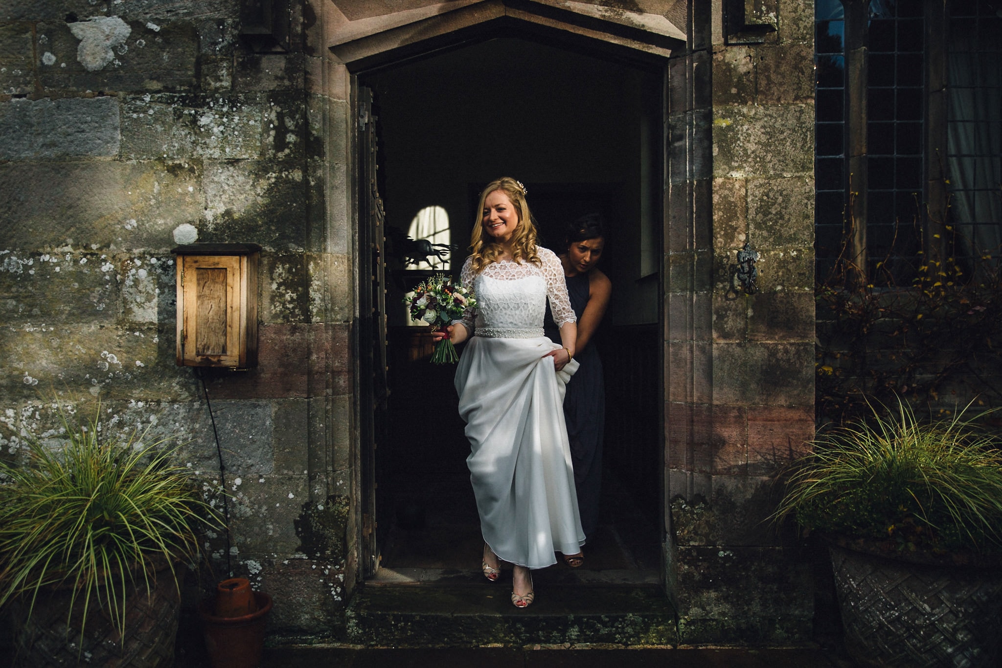 bride leaving Askham Hall Charlie Brear gown 