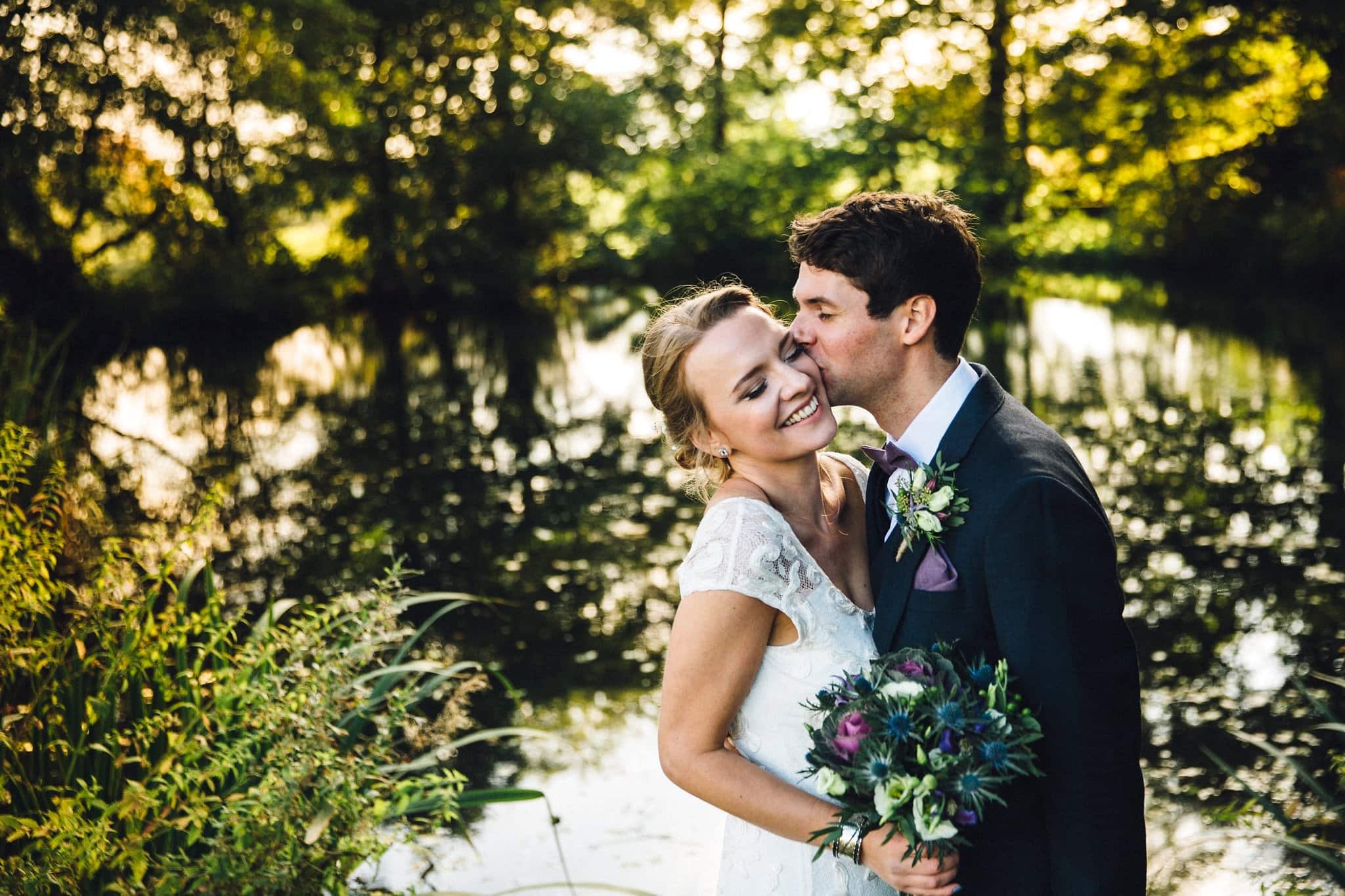 Wedding kiss by lake