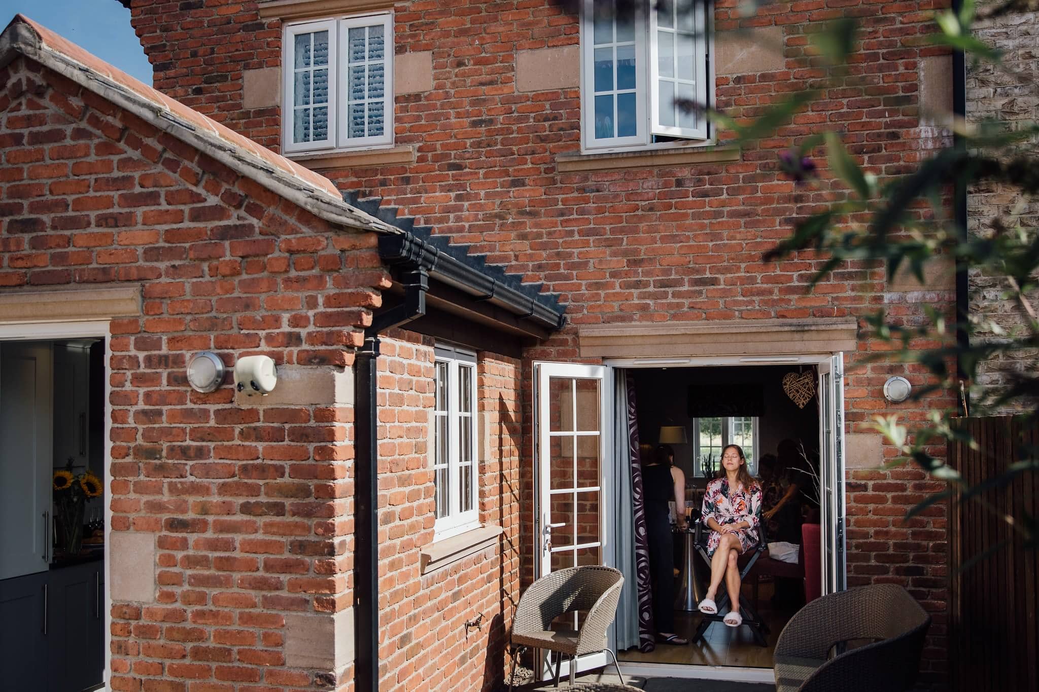 bride getting ready in floral dressing gown 