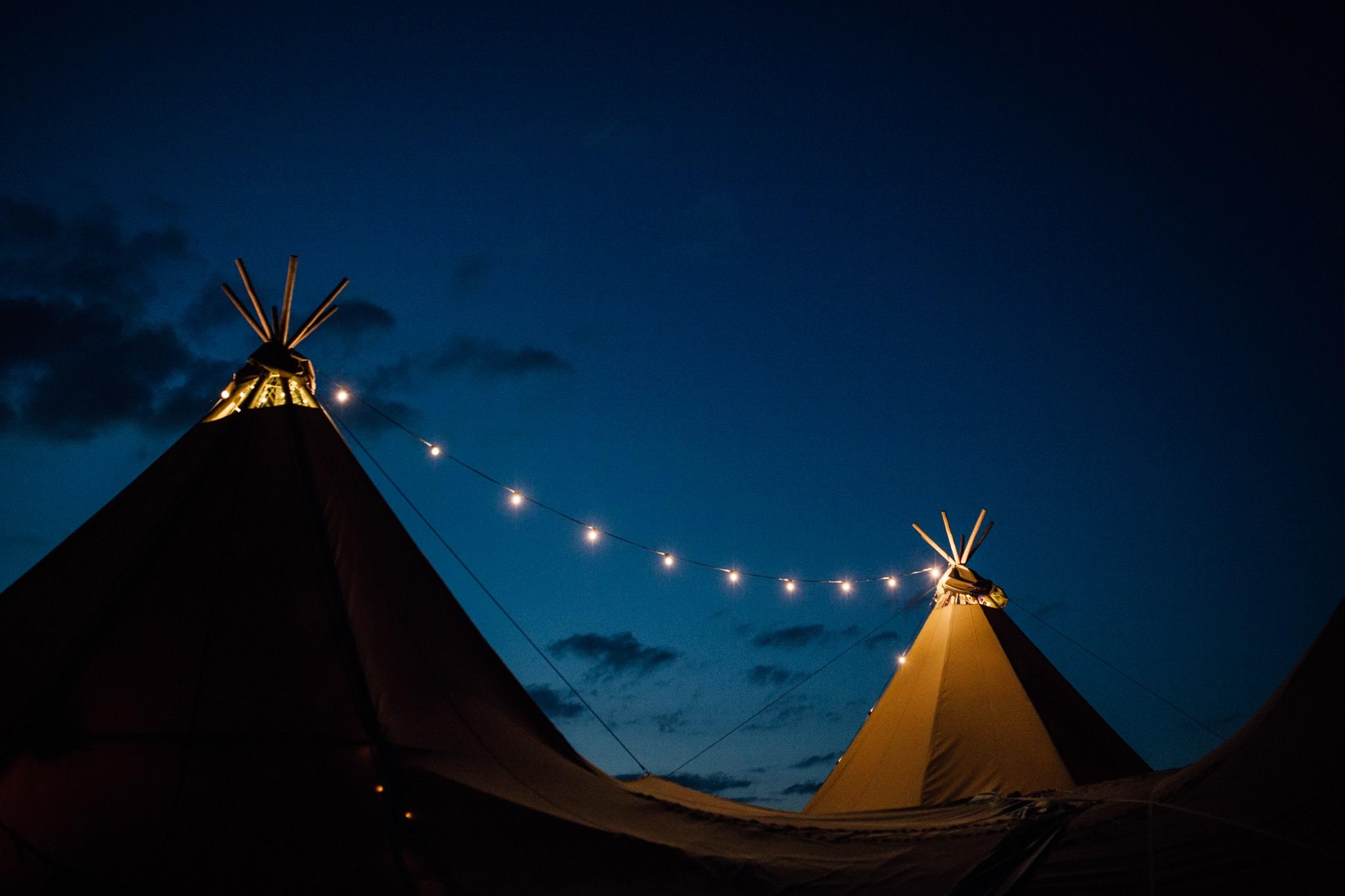 tipi garden wedding at night with festoon lights