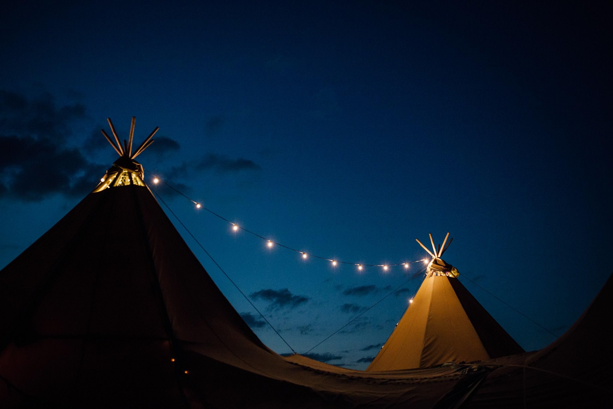 tipi garden wedding at night with festoon lights