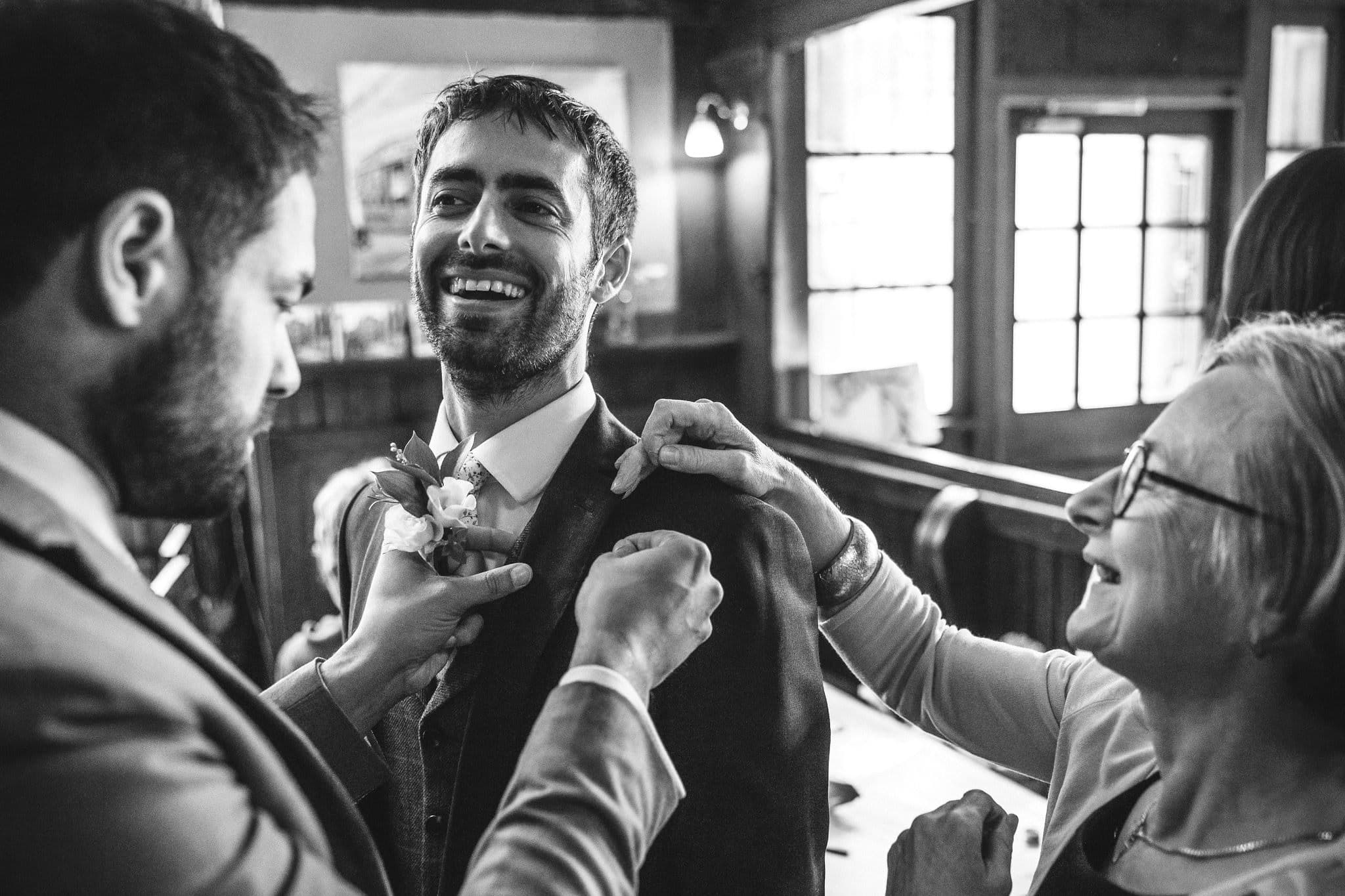 black and white reportage shot of groom