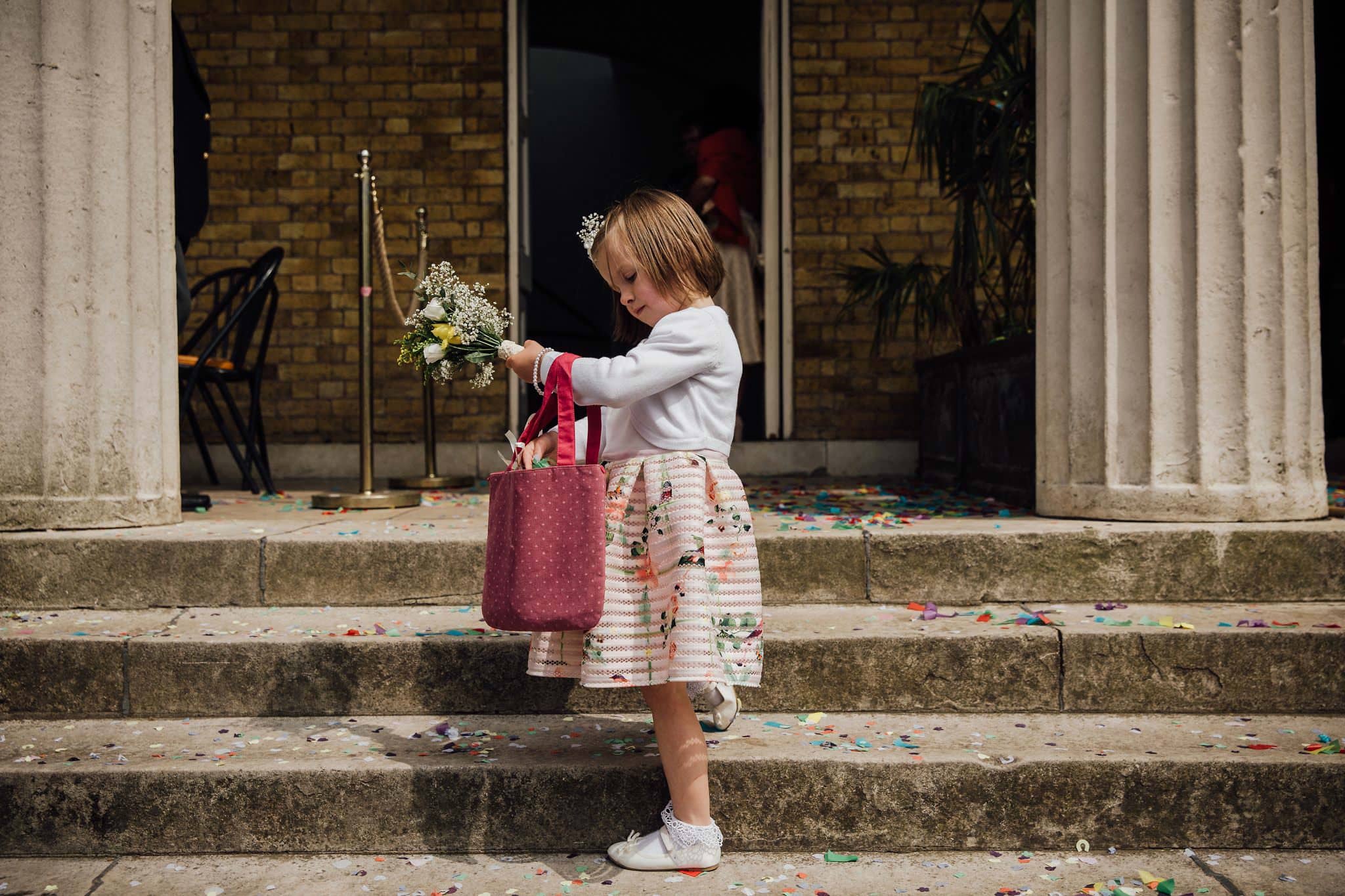 flower girl collecting confetti