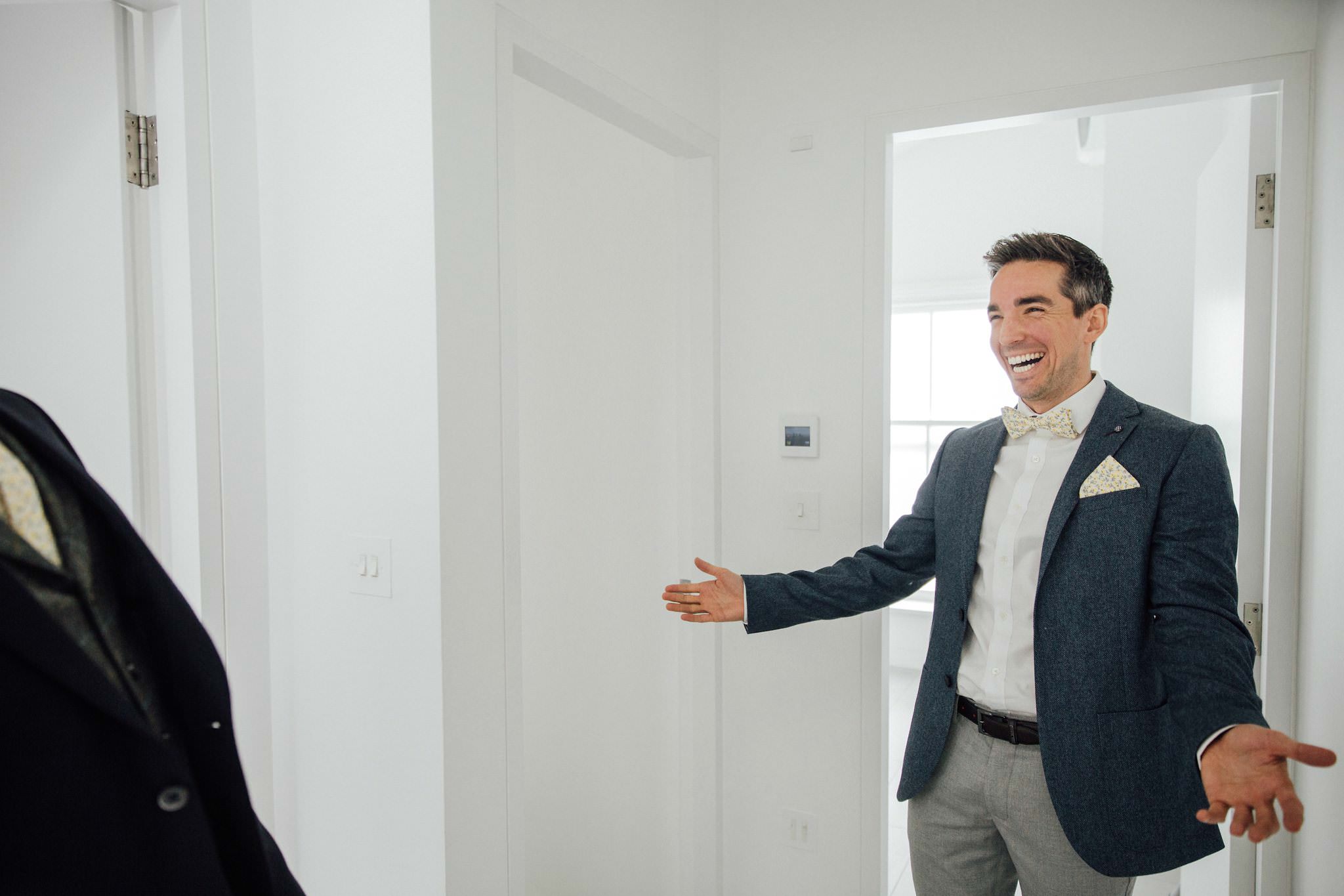 gay wedding groom in blue suit and bow tie