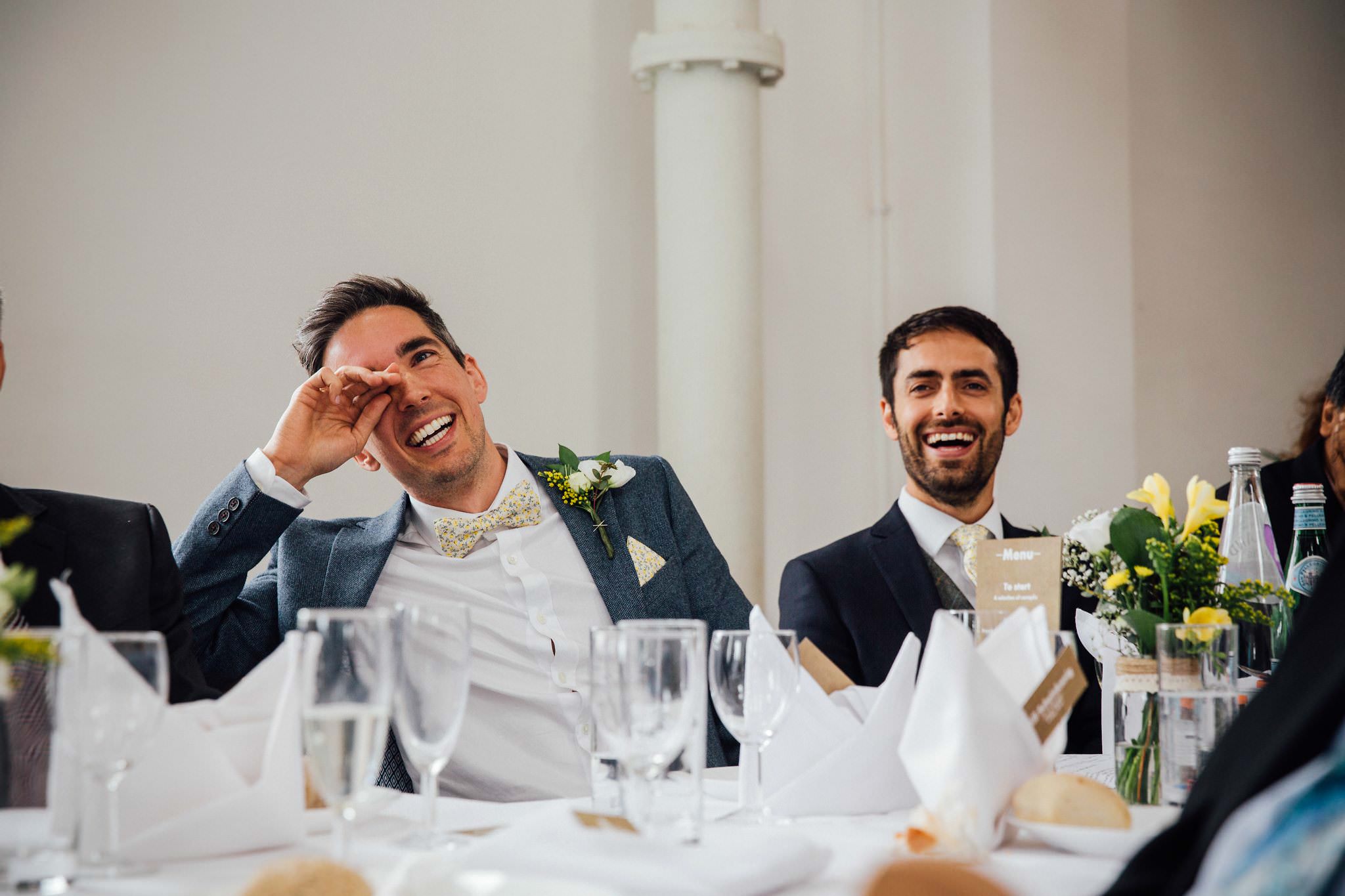 groom laughing at best man's speech