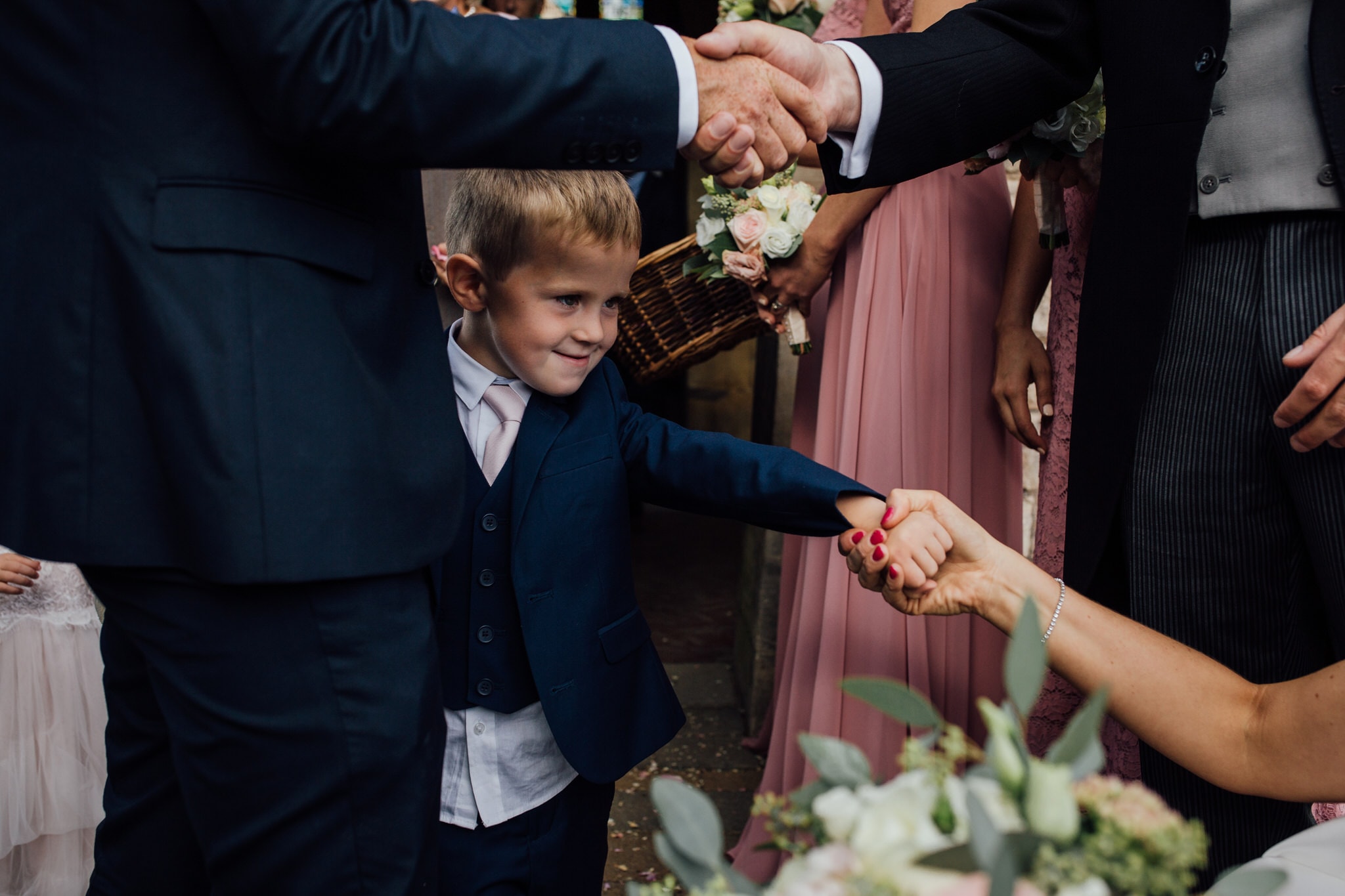 kid holding brides hand