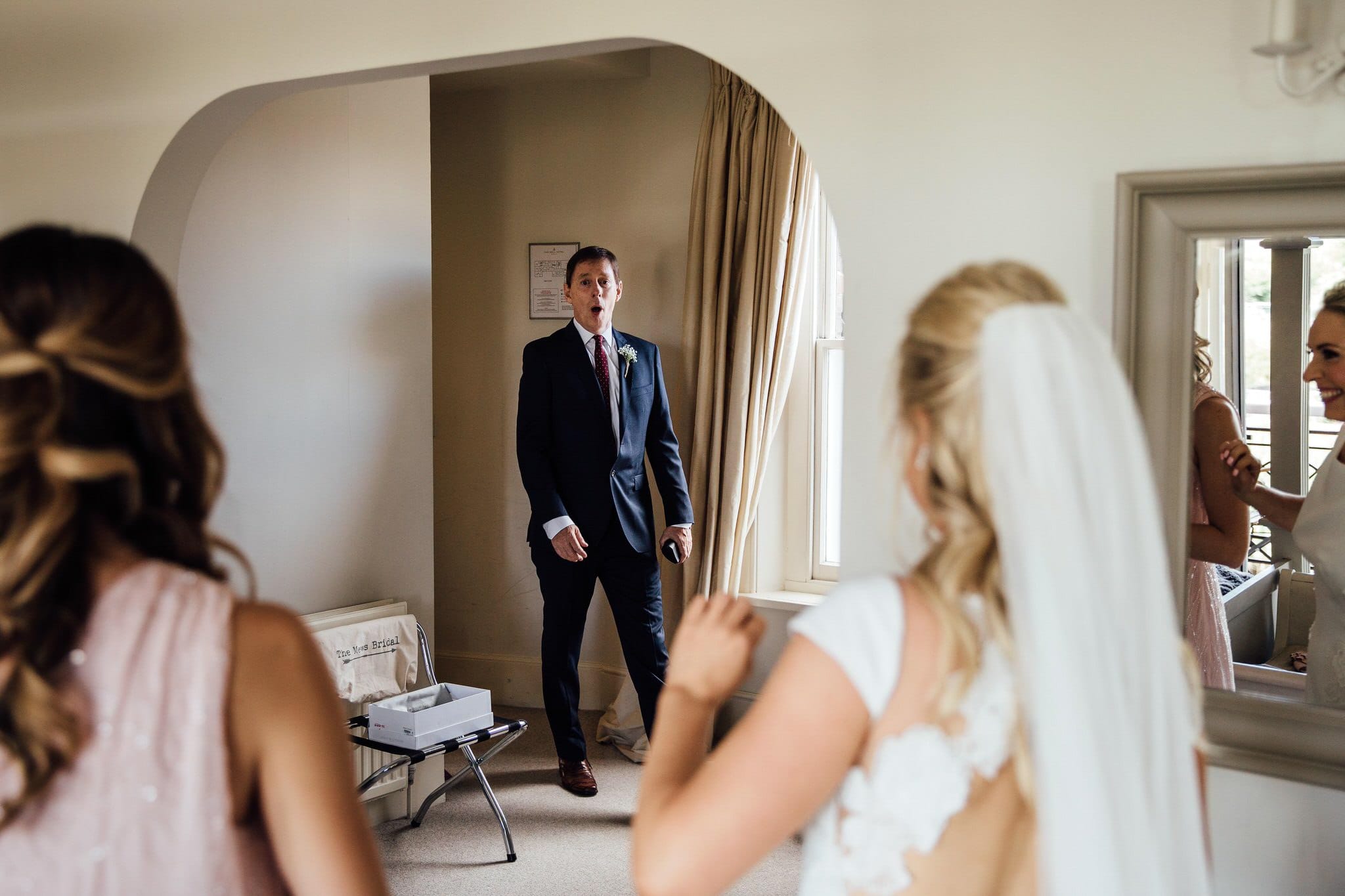 father of the bride seeing daughter in her wedding dress