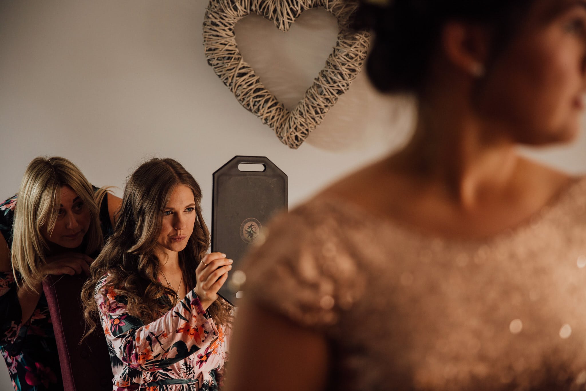 bride checking makeup in mirror