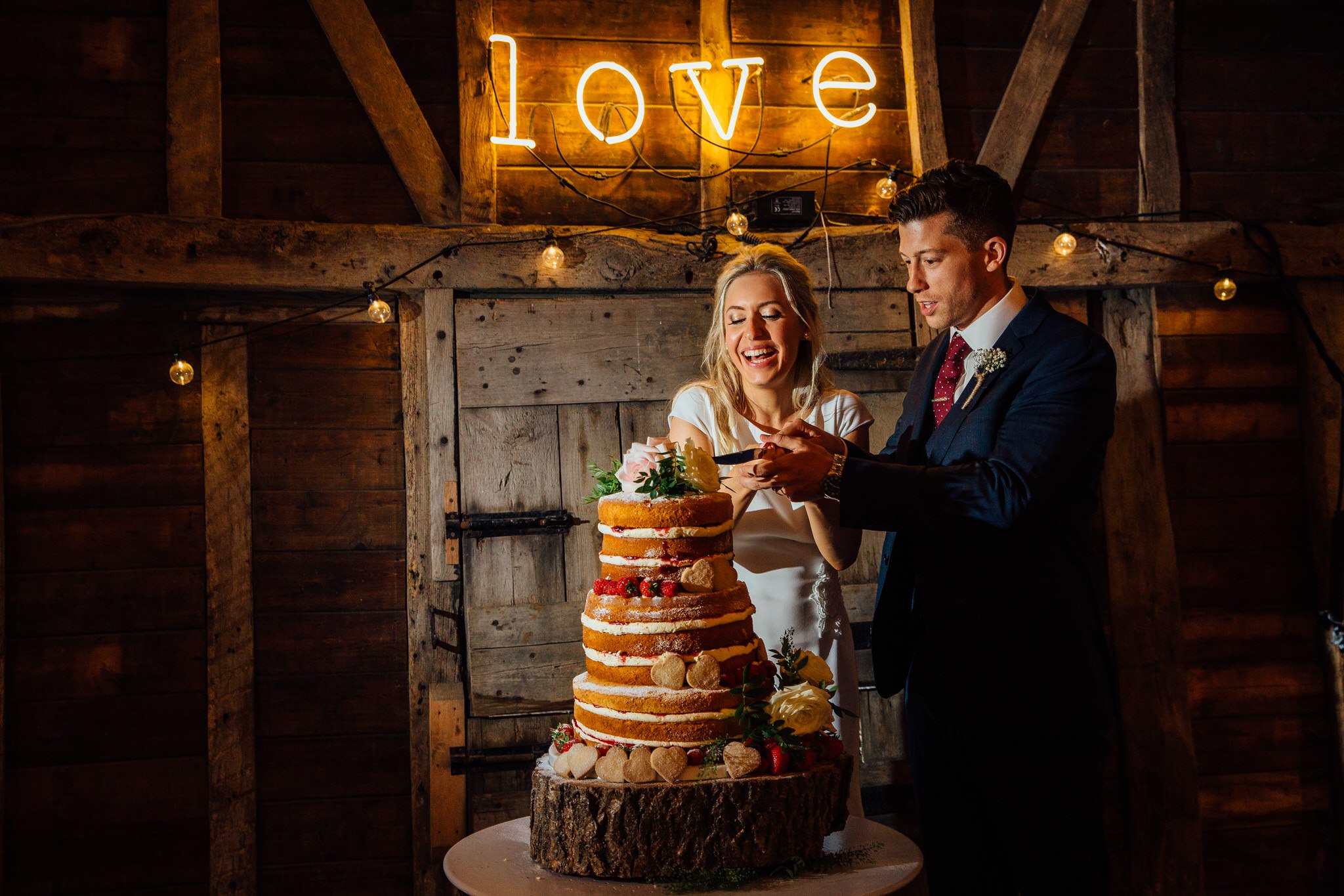 cutting cake love neon sign