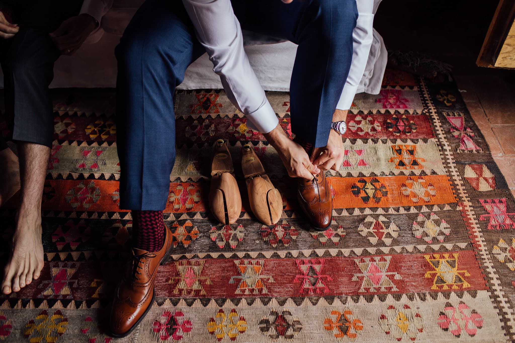 Groom's brogues on colourful rug in Castello di Bibbione