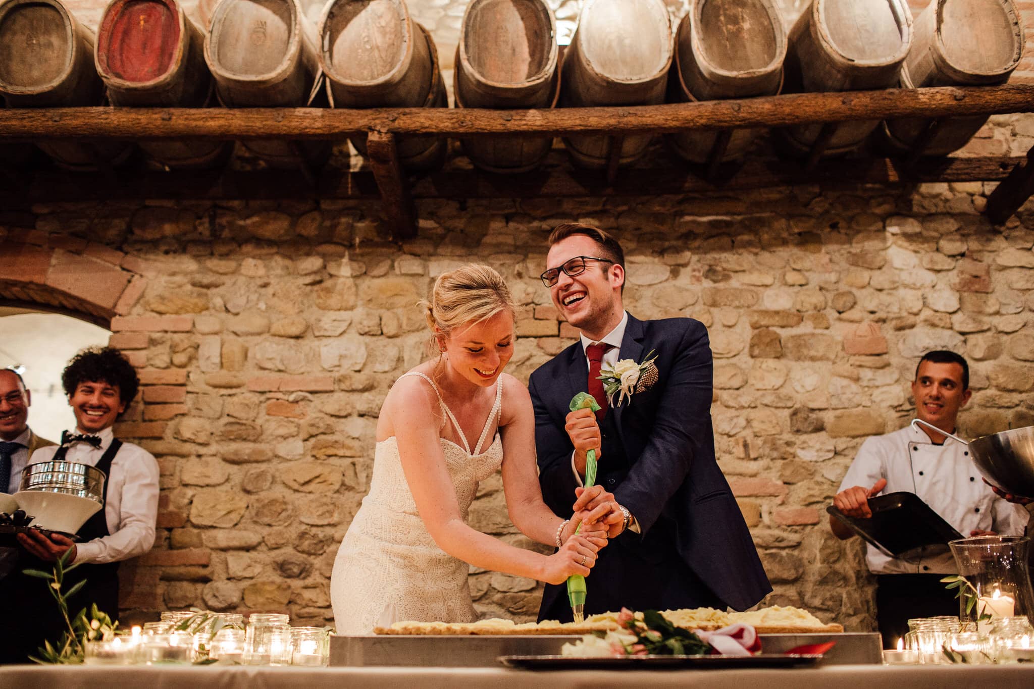 Italian wedding tradition bride and groom make cake