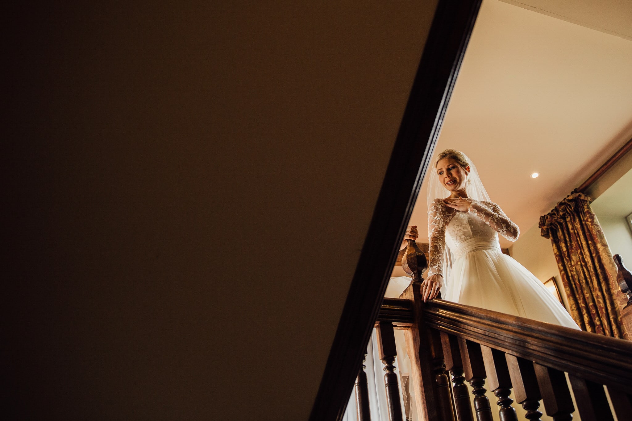 bride on stairs at Dewsall Court