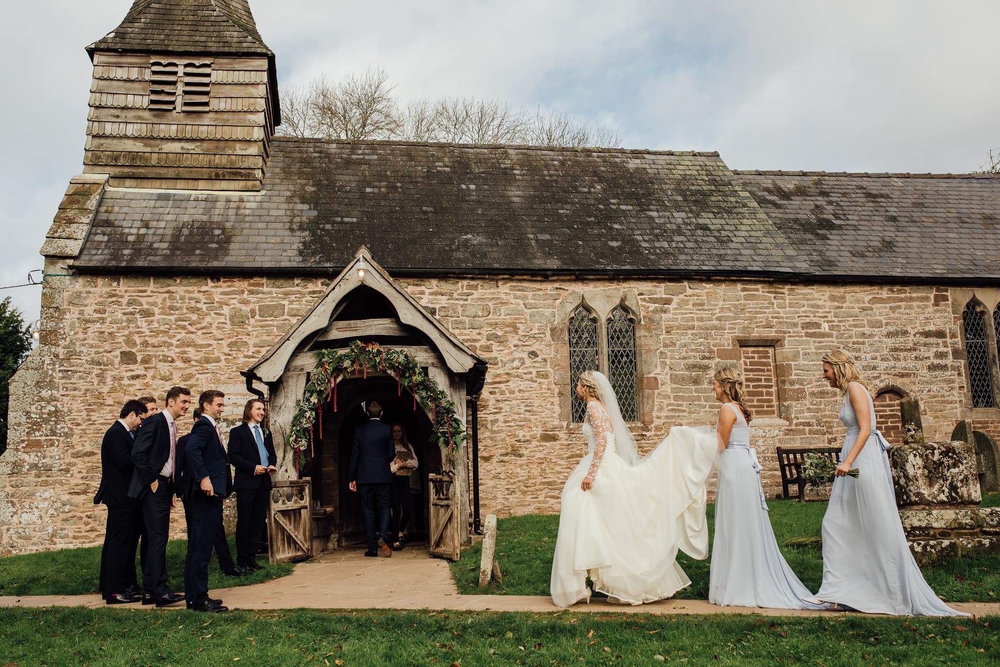 bride arrives at church for Dewsall Court wedding service