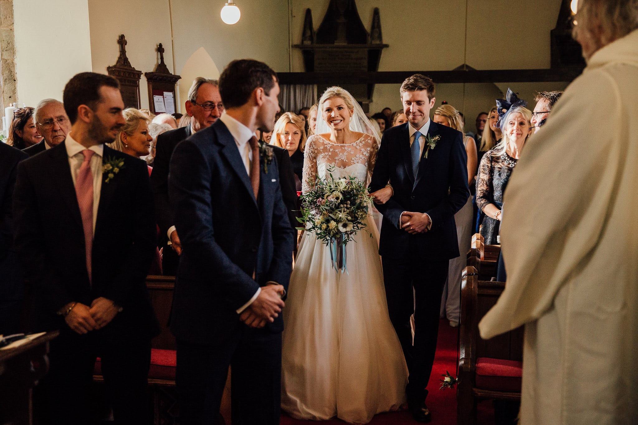 bride walking down the aisle smiling