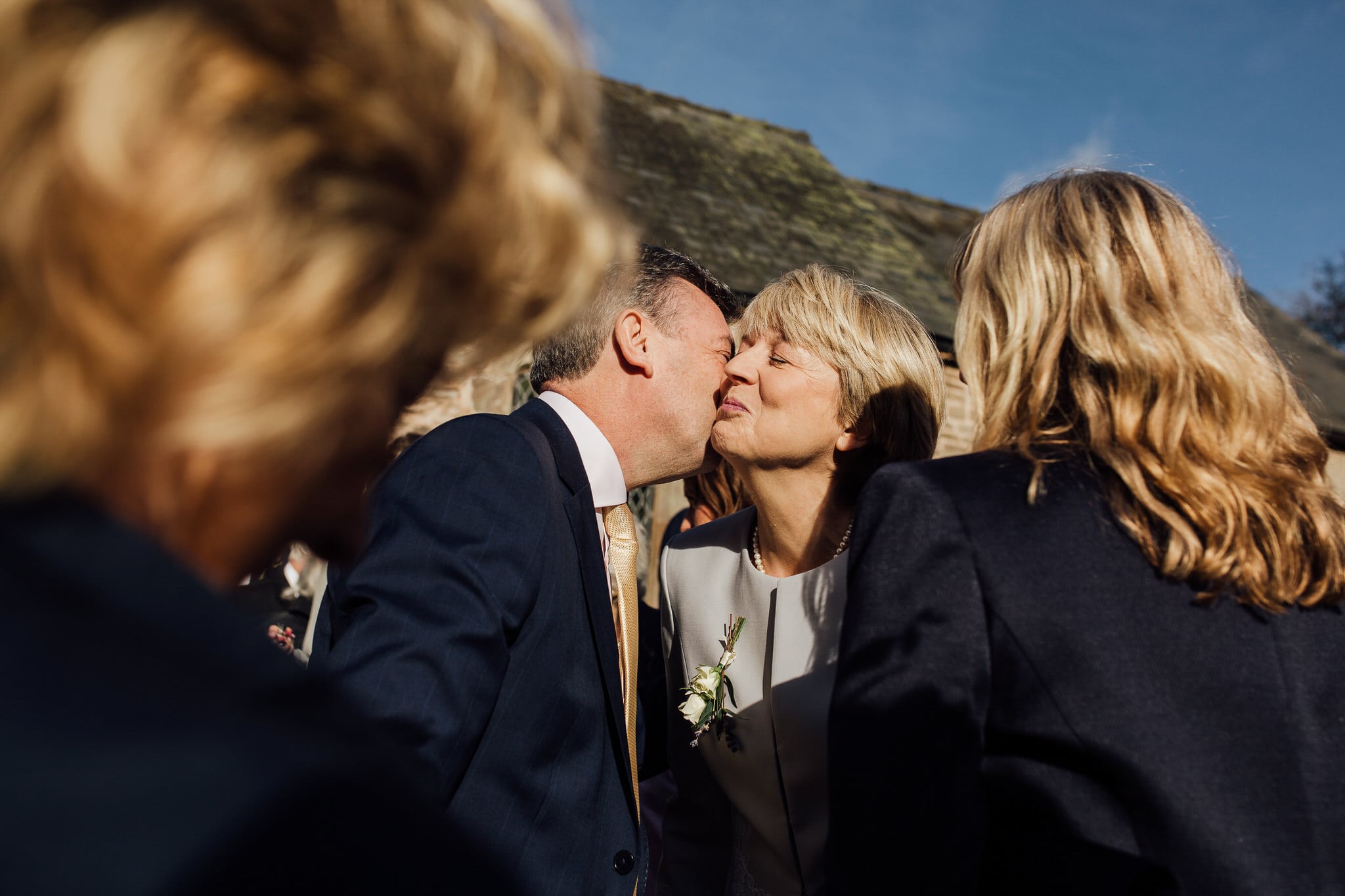 mother of the bride kissing friend