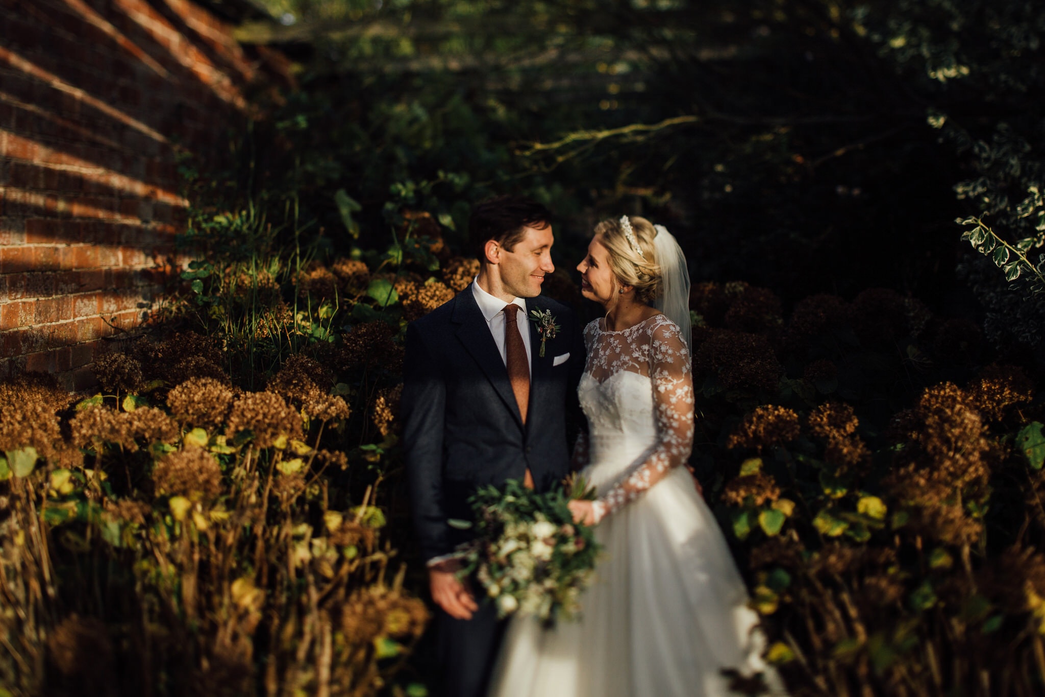 portrait of bride and groom with tilt shift lens caught in natural golden highlights
