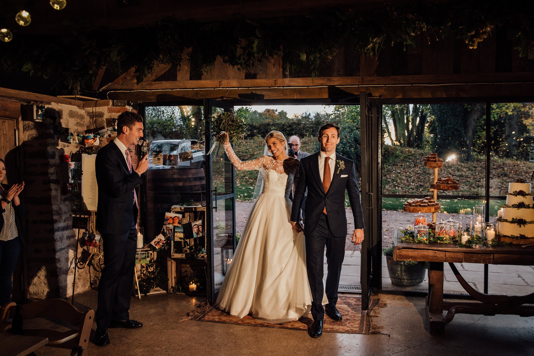 bride and groom enter barn for meal