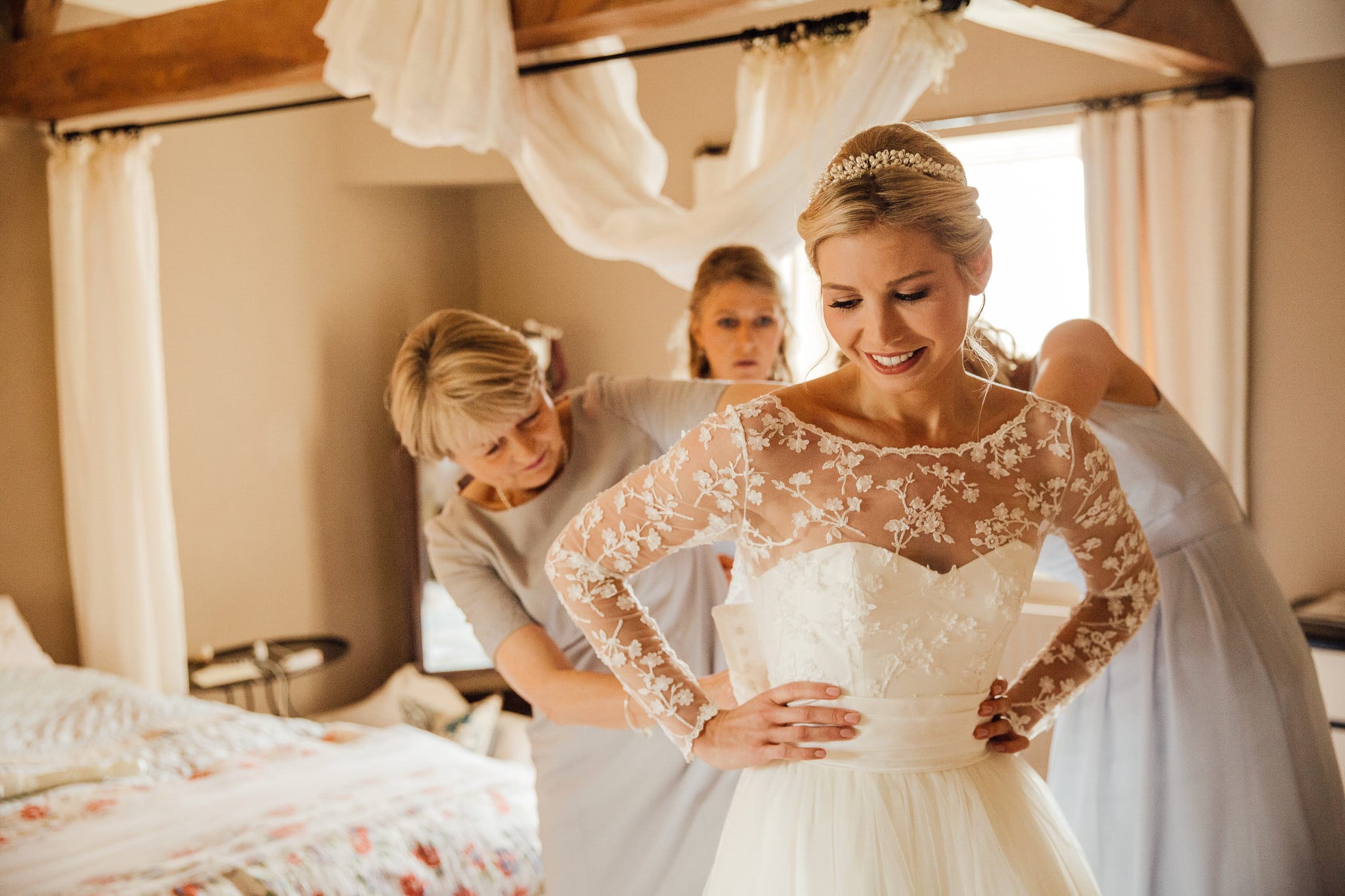 mother of the bride helping with wedding dress