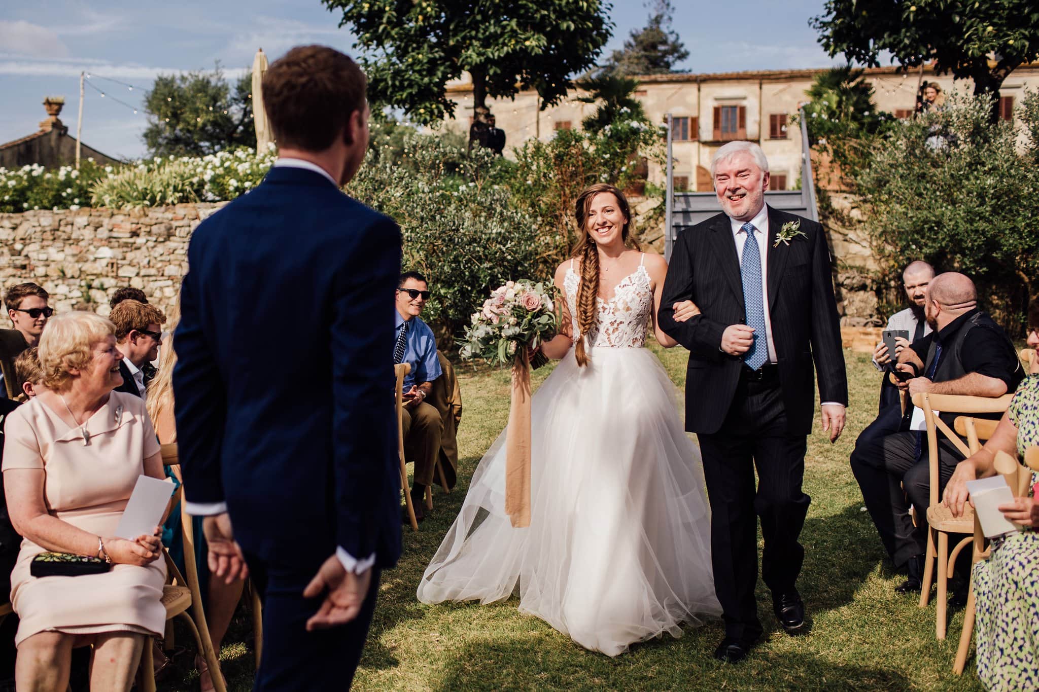 happy bride arriving at Villa Medicea di Lilliano ceremony