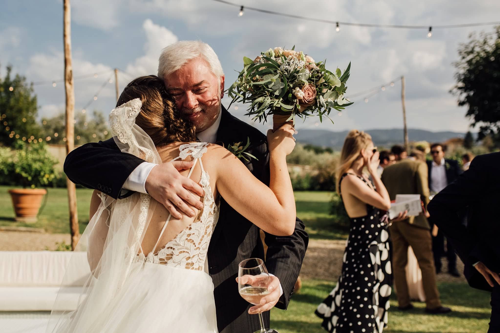 father of the bride cuddling his daughter