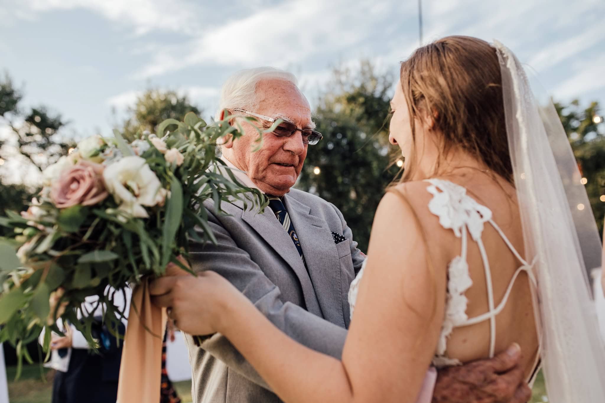 grandad admiring bride's dress