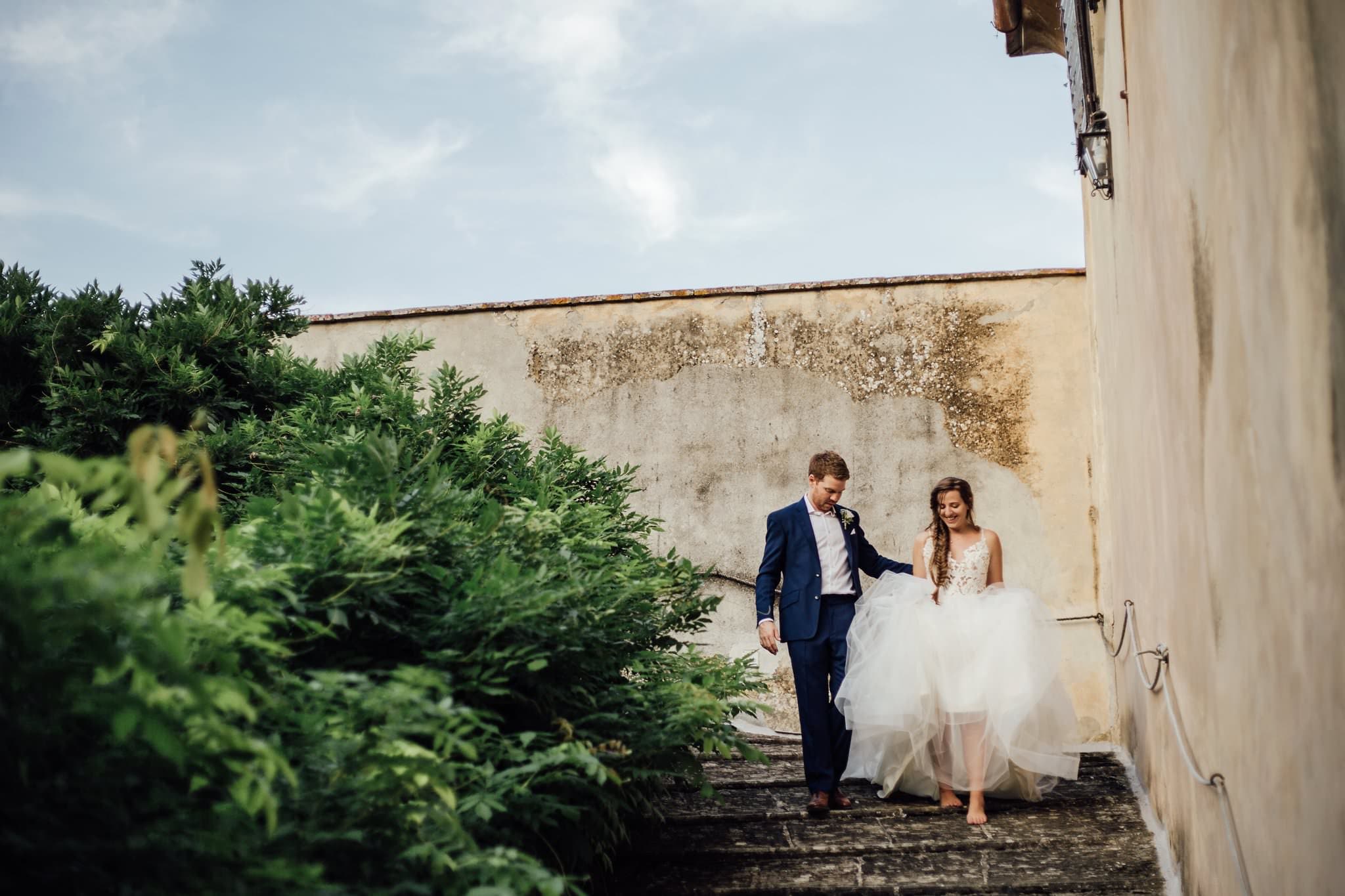 bride and groom walking down steps barefoot at Villa Medicea di Lilliano, Florence, Italy, Destination Wedding