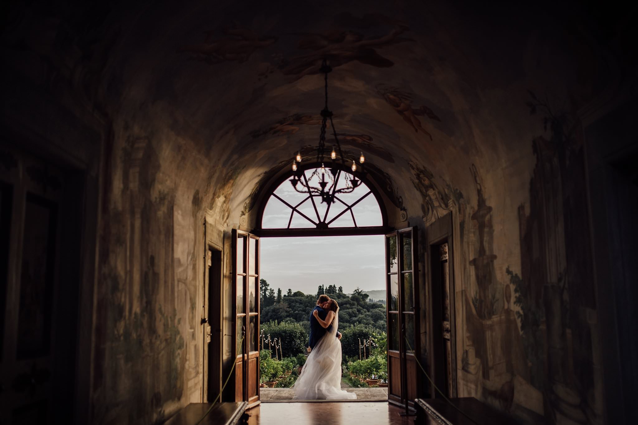 bride and groom hugging on the steps at Villa Medicea di Lilliano, Florence, Italy