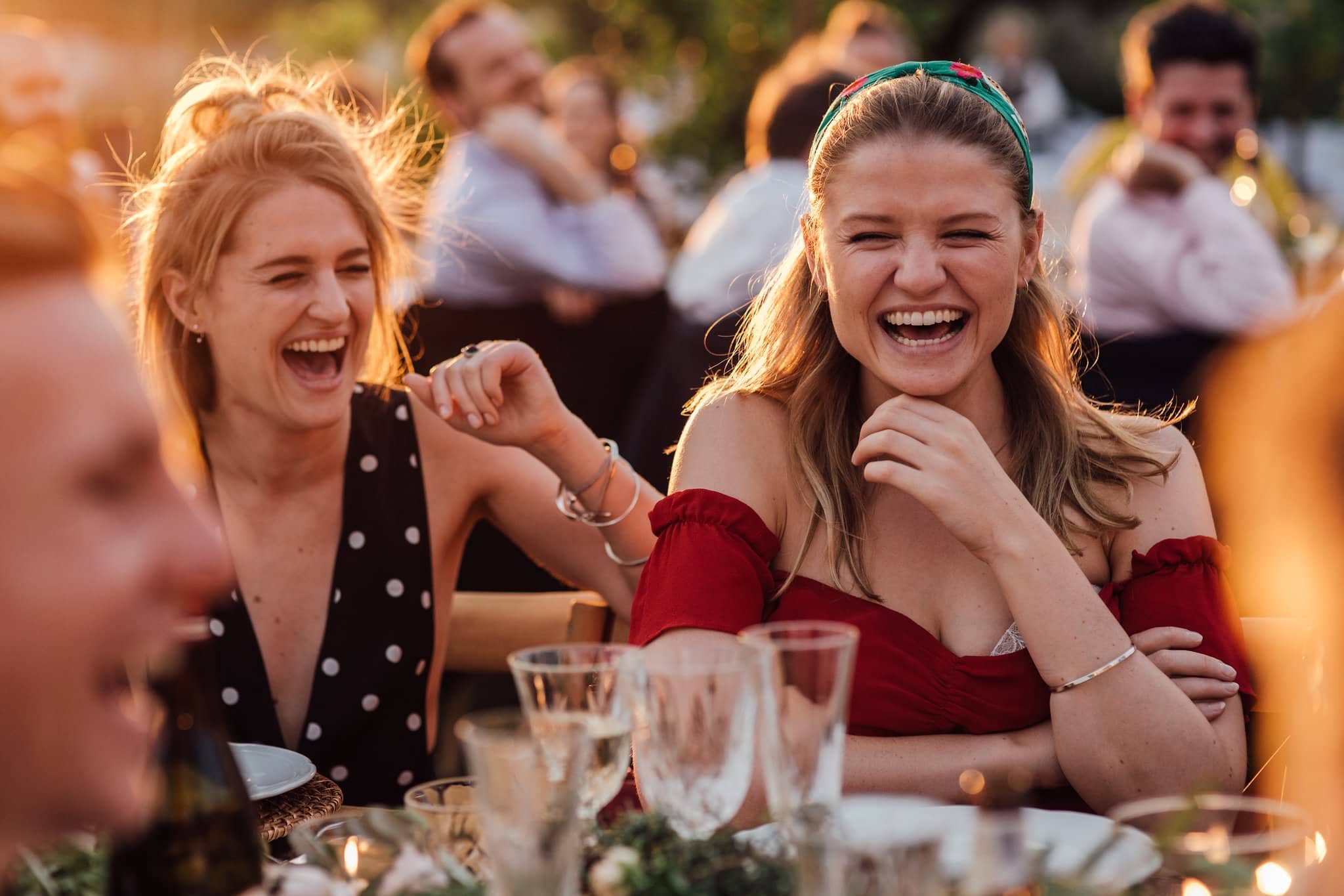 golden hour at destination wedding for speeches, guests laughing