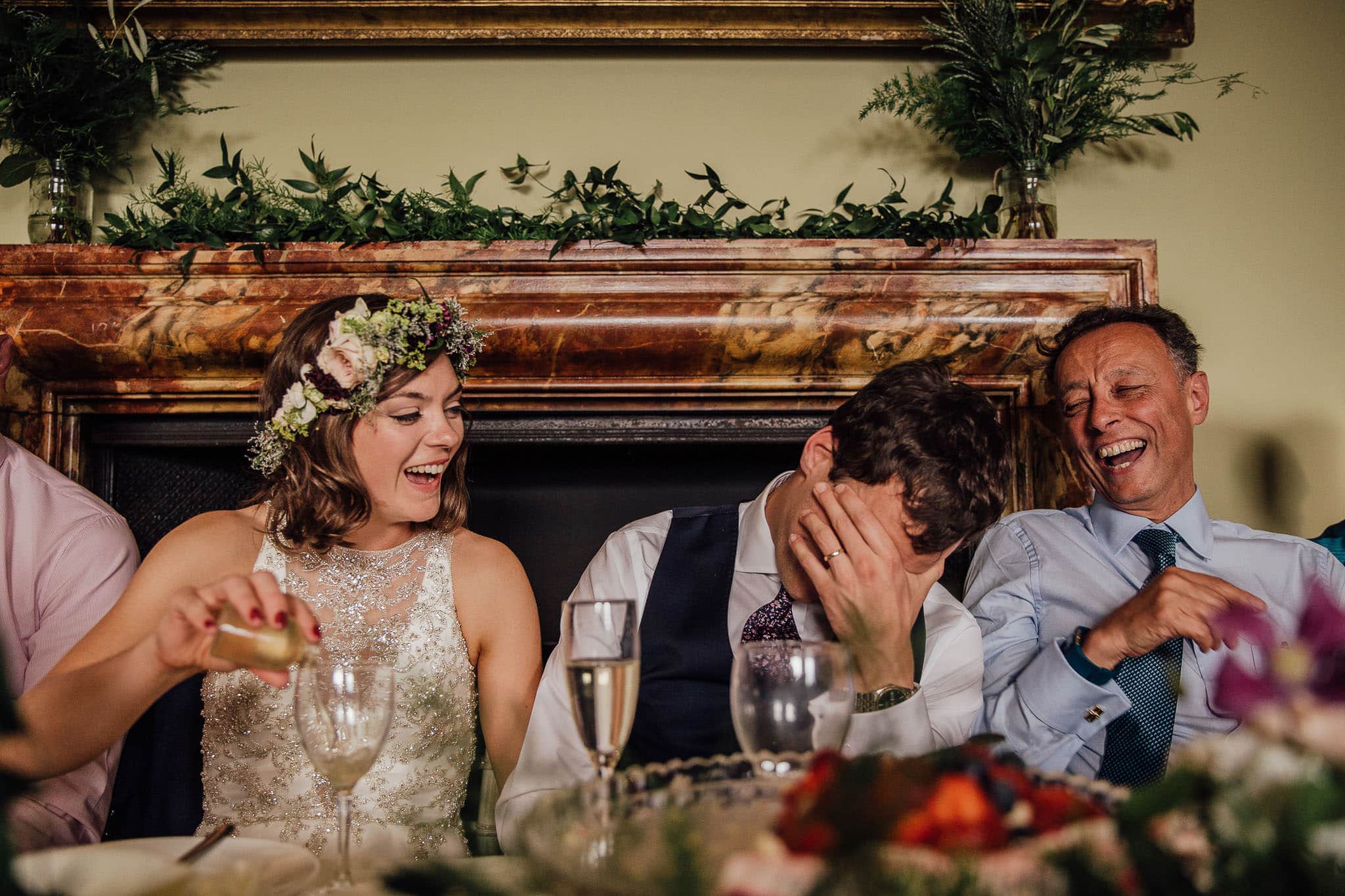 bride and grooming laughing at speeches