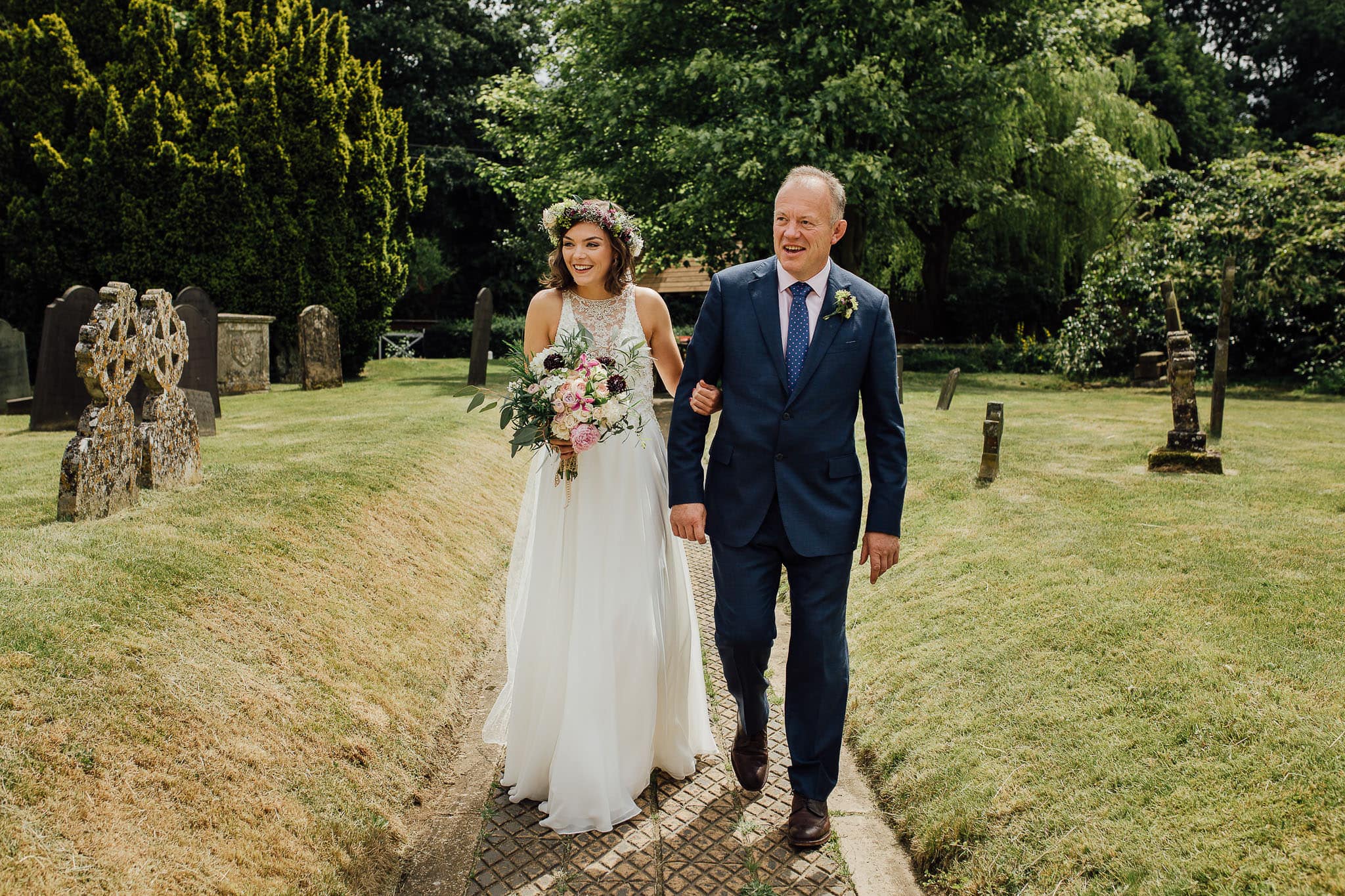 bride in maggie sitters gown walking to church