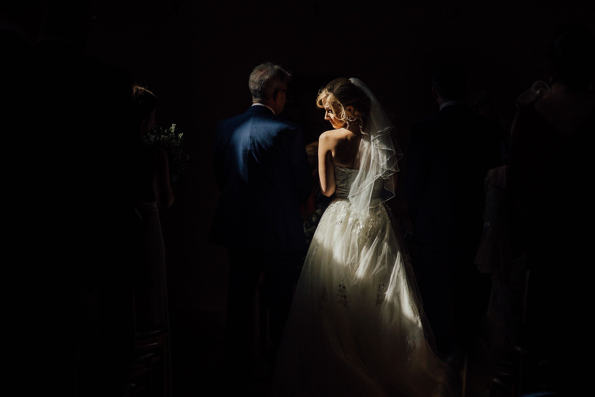 chiaroscuro photo of bride caught in spotlight