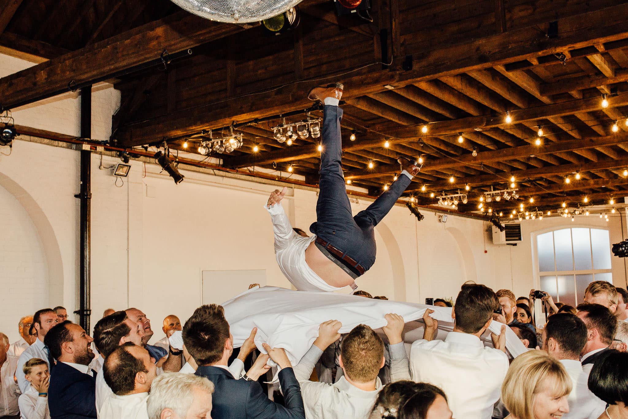 jewish dancing groom in air at london wedding