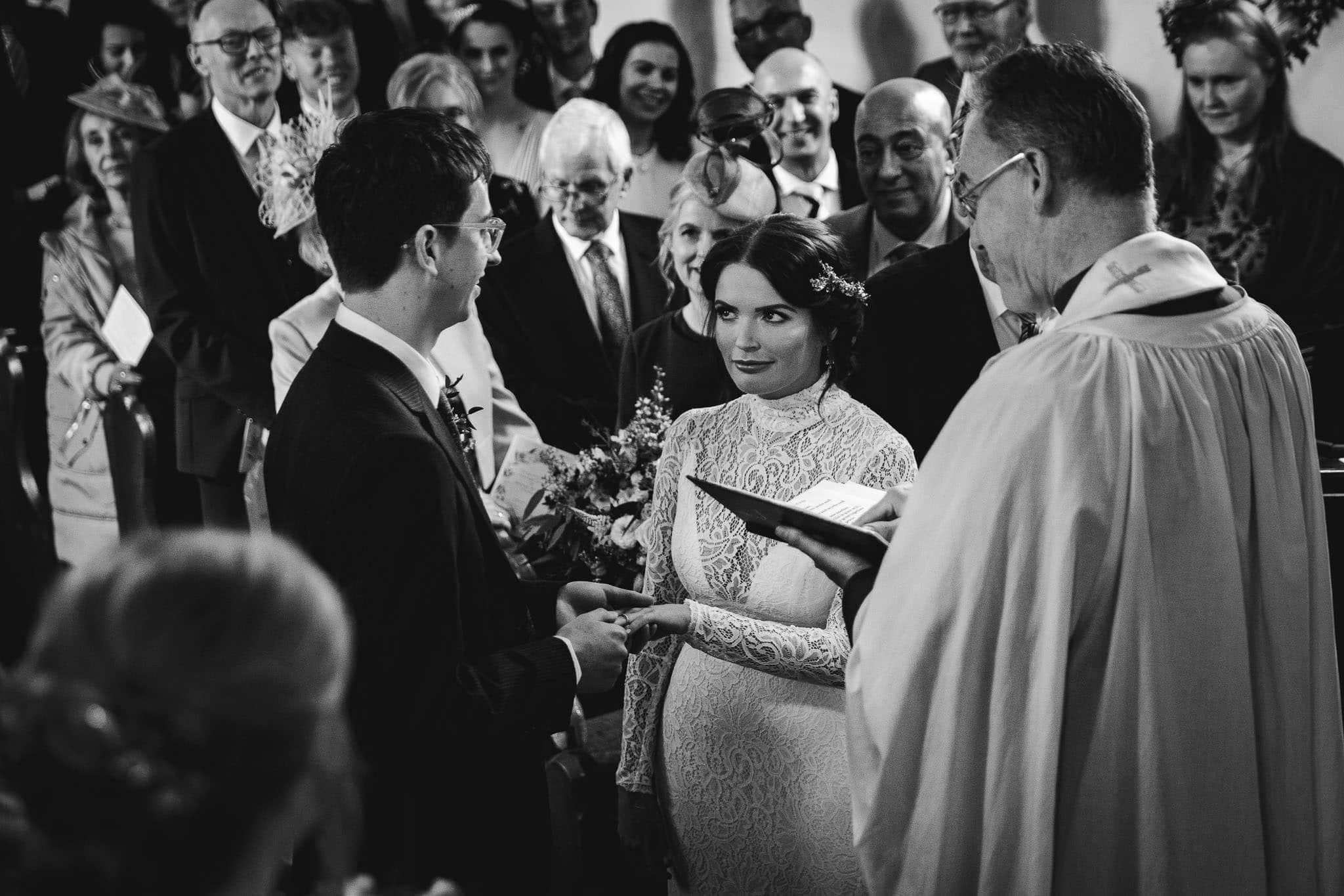 black and white photograph of bride and groom at Dewsall Court church