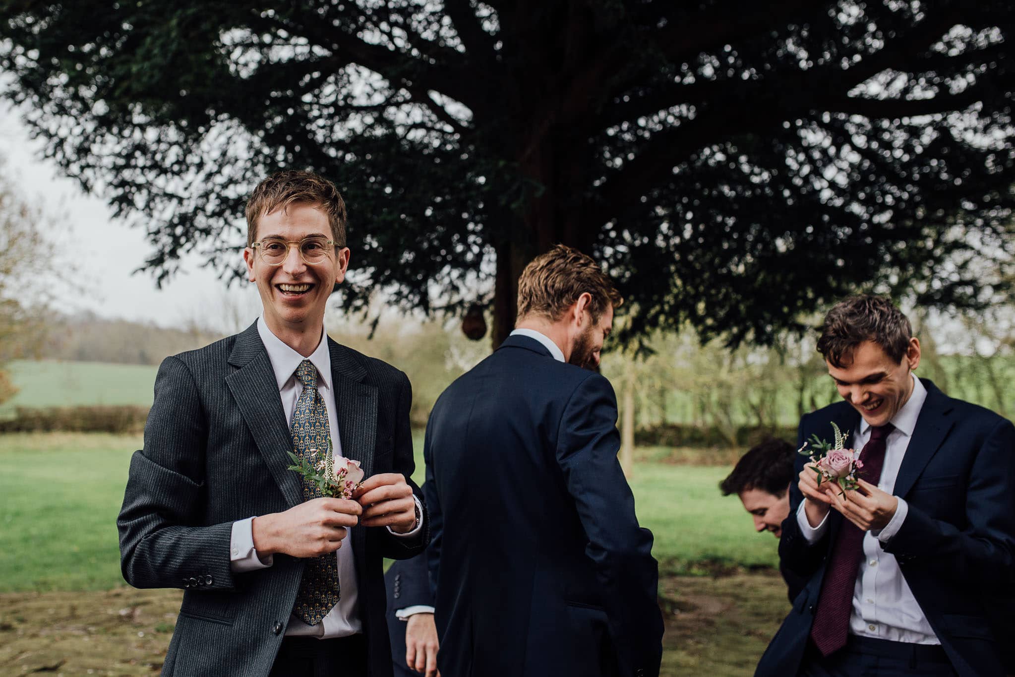 groom putting on buttonhole