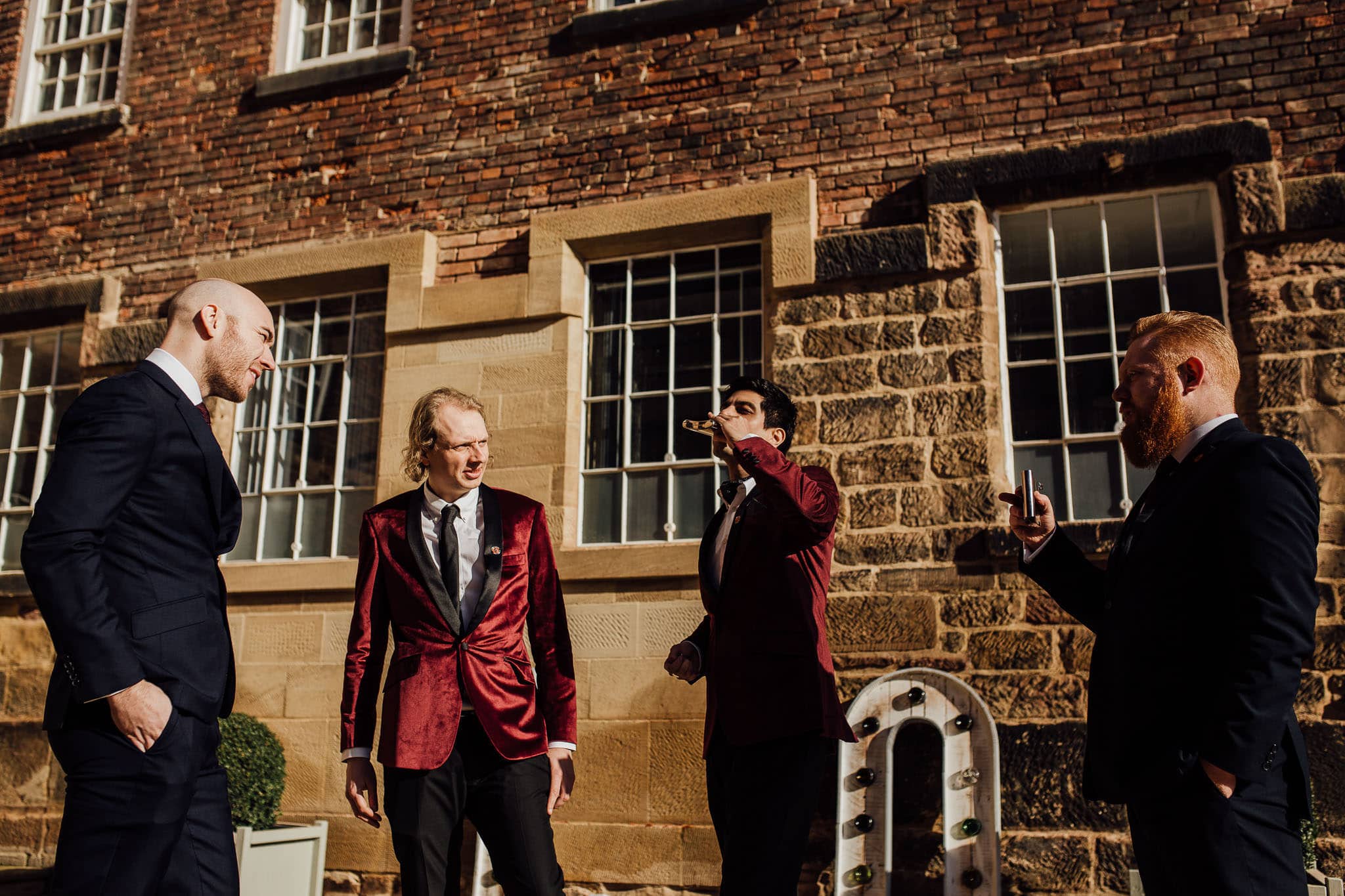 maroon suit jacket groomsmen at west mill