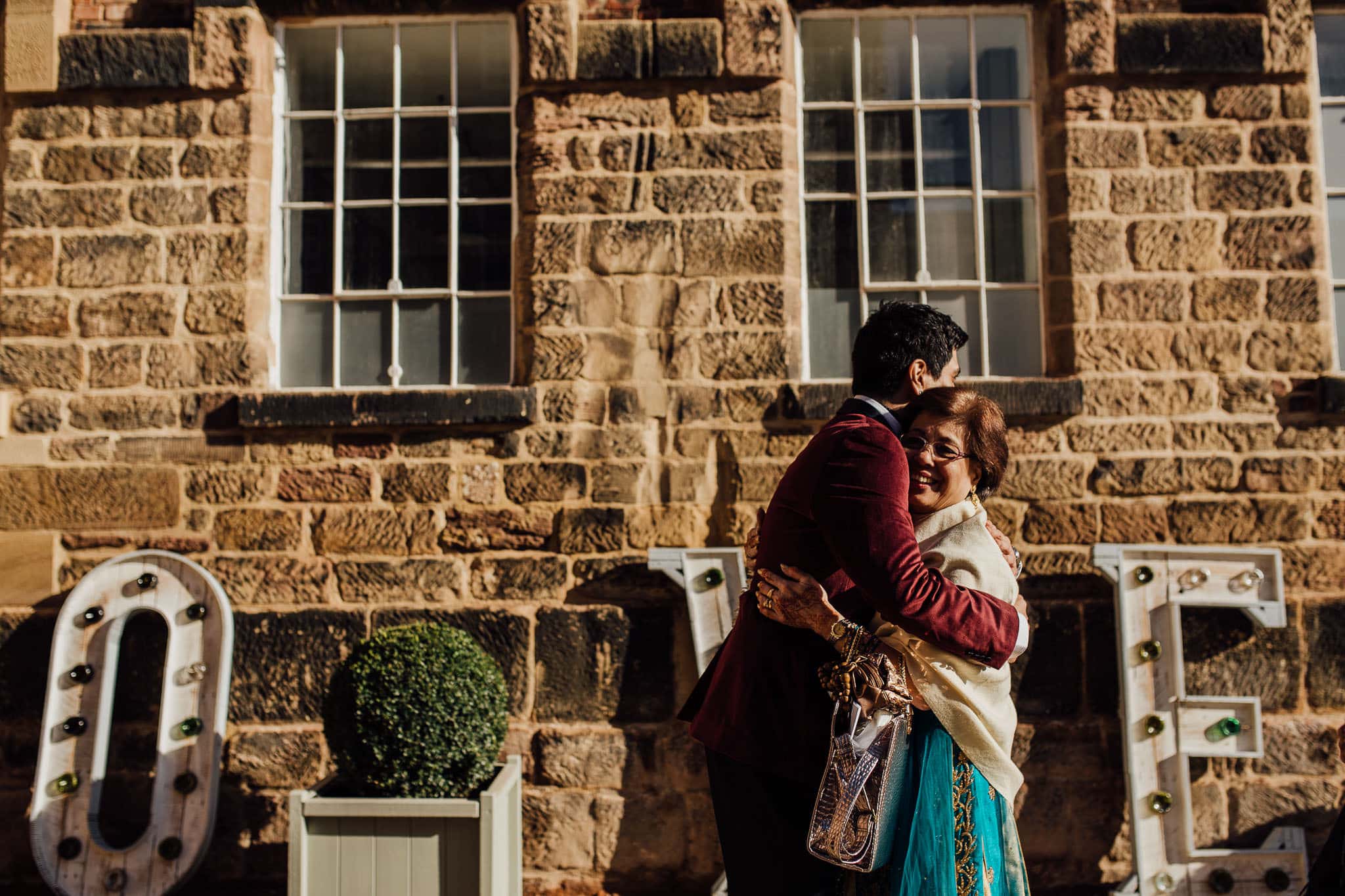 groom hugging his mum on wedding morning