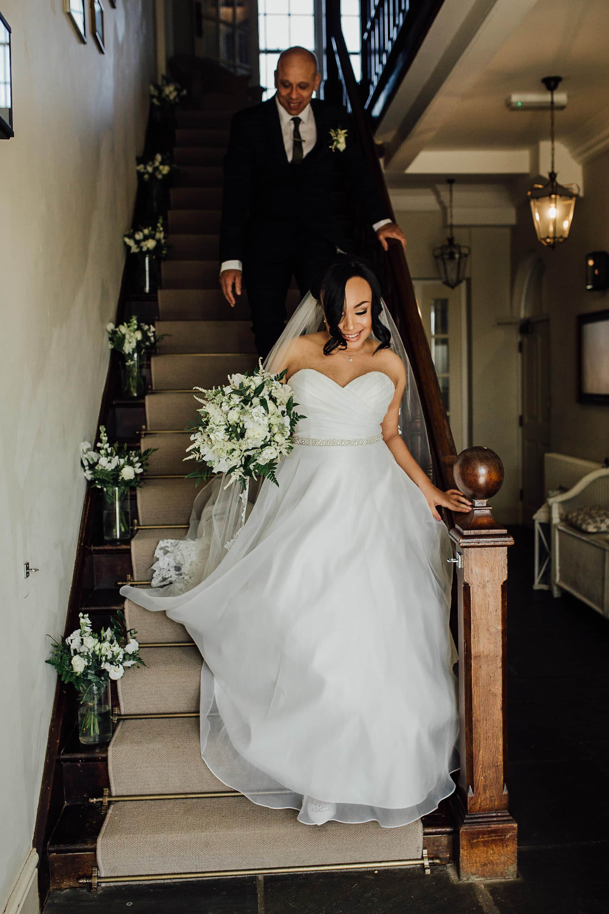 portrait of bride on stairs at the kedleston country house wedding venue