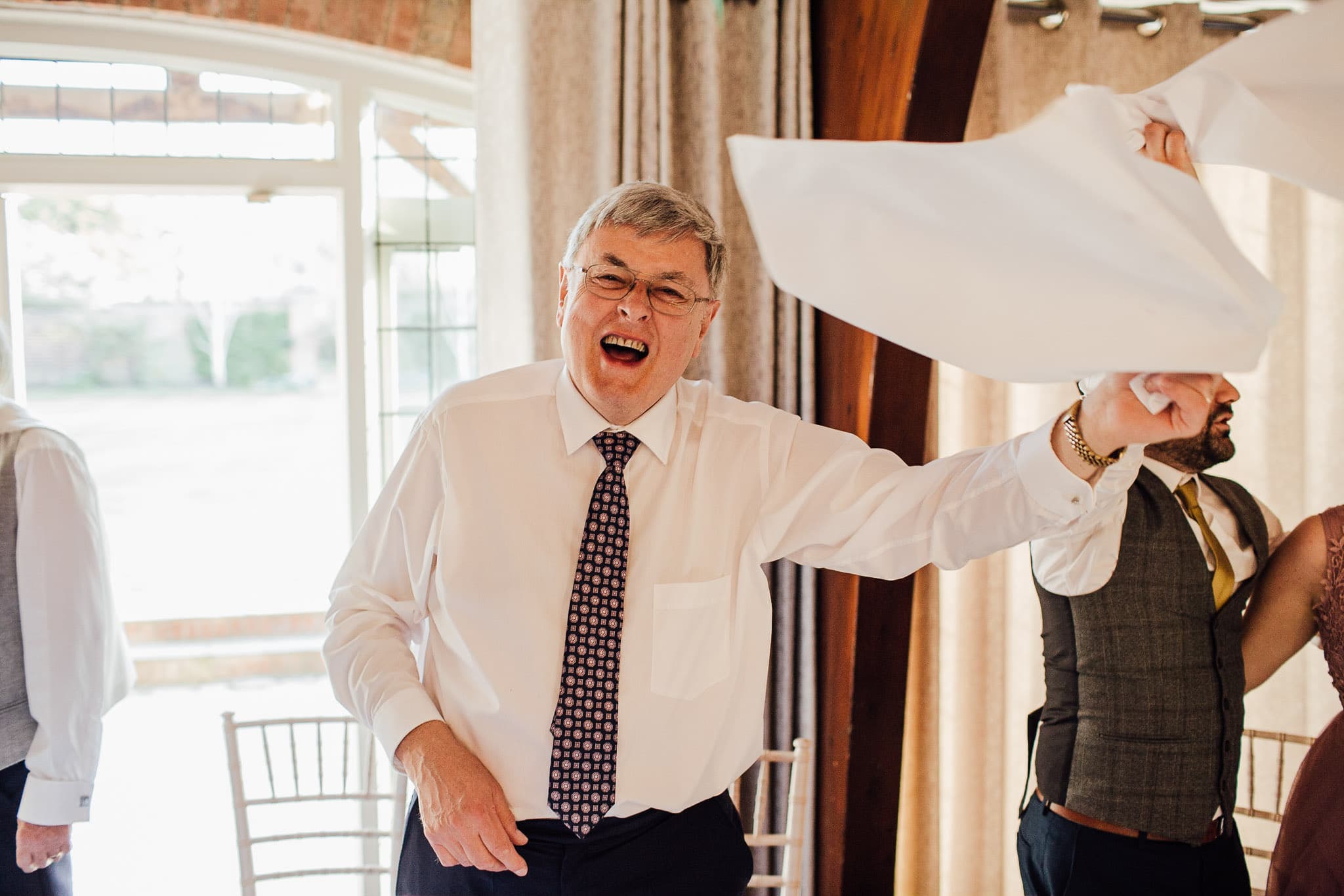 father of the groom dancing with napkin