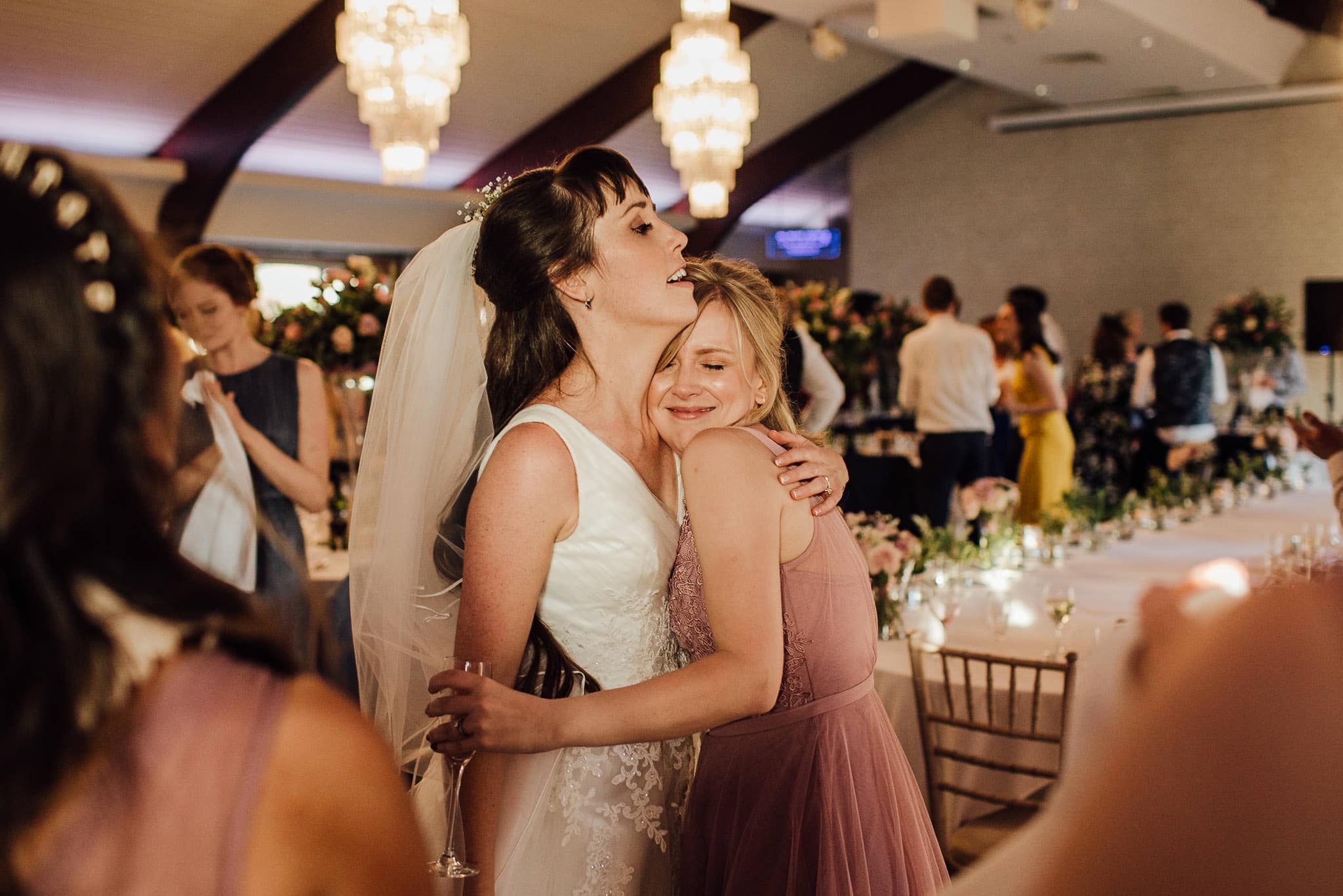 bride cuddling maid of honour