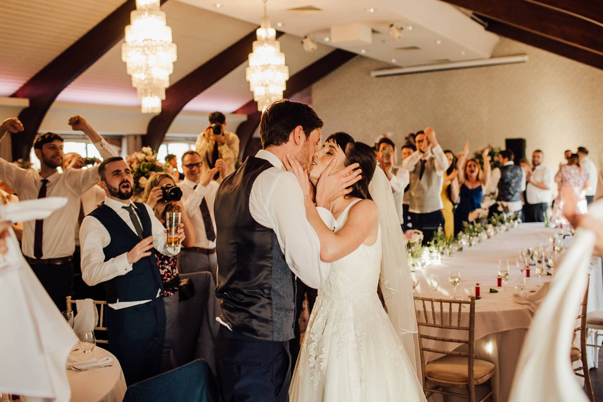 candid capture of bride and groom kissing