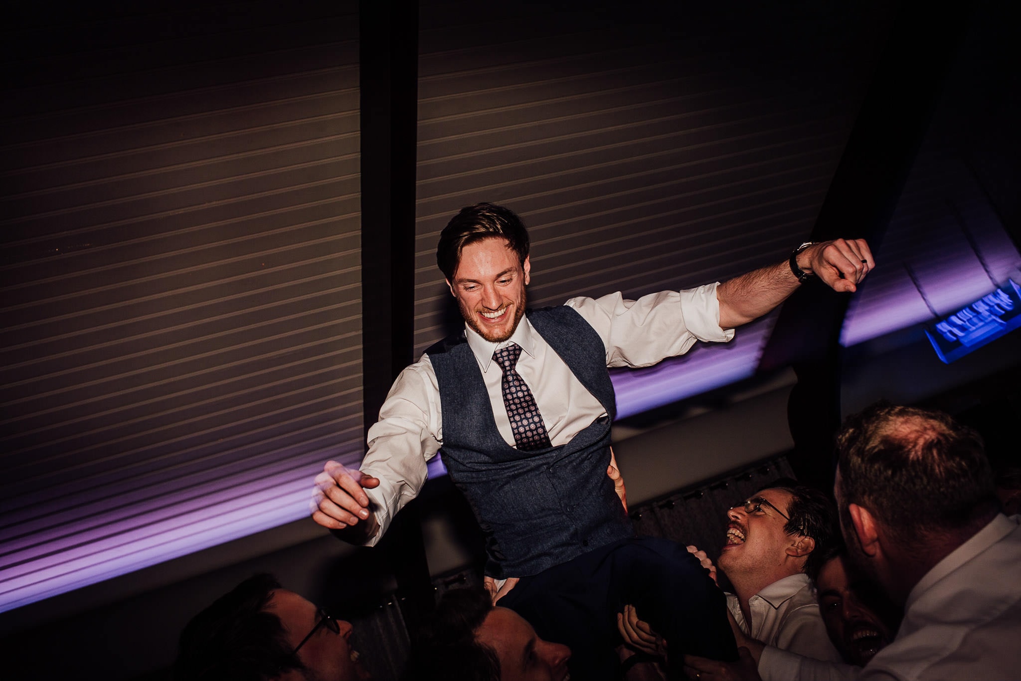 groom in the air on dance floor