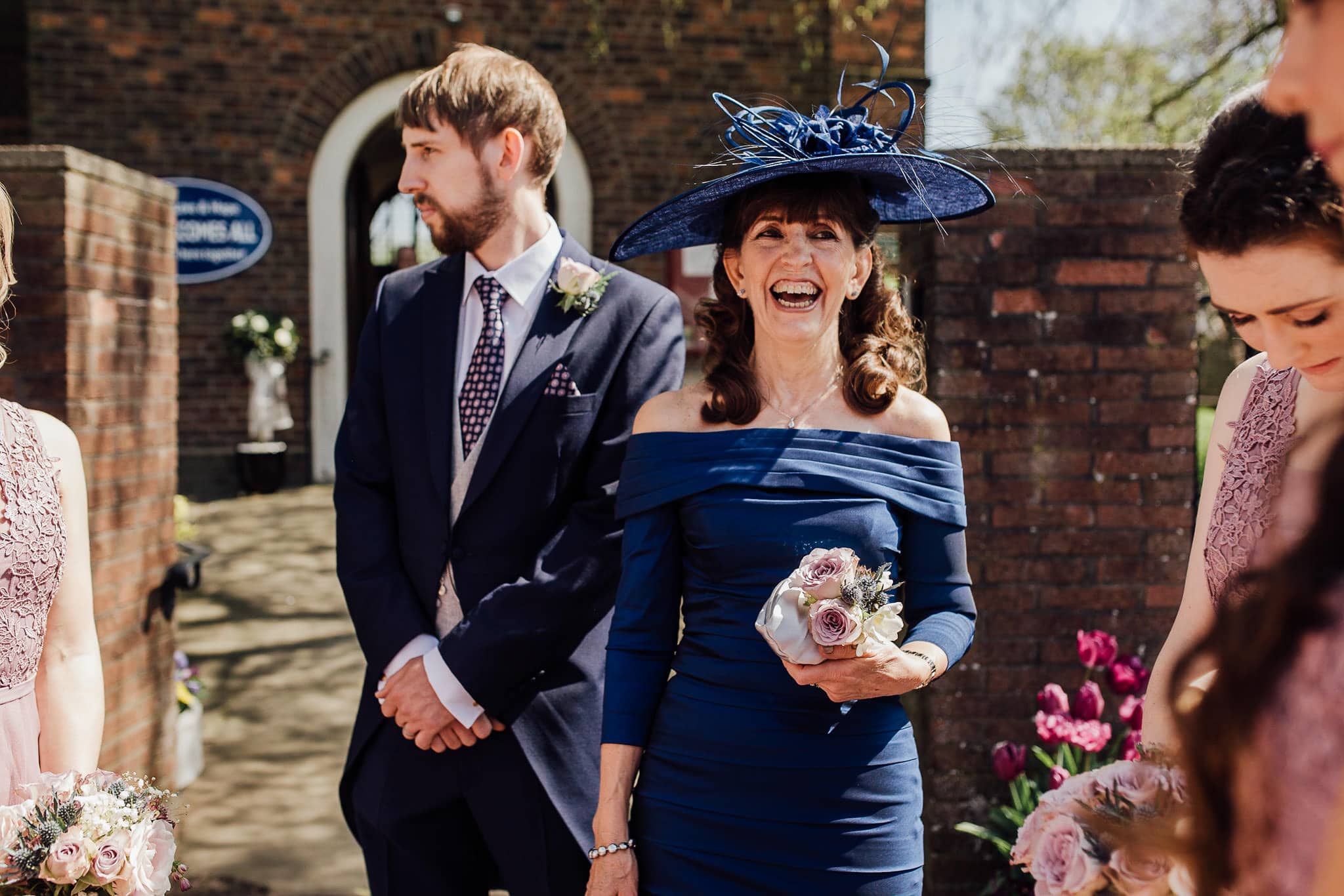 mother of the bride in blue dress with blue hat