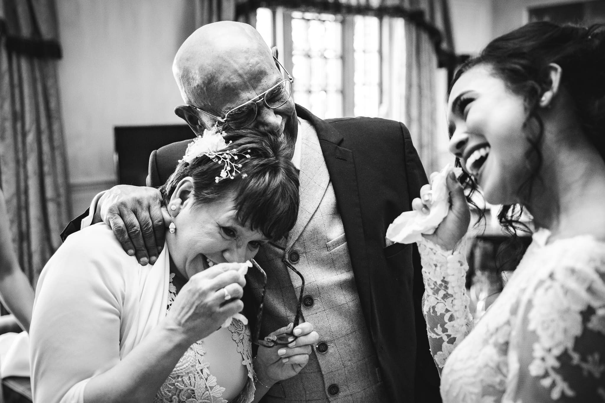 parents and bride crying after Father of the Bride sees her in wedding dress