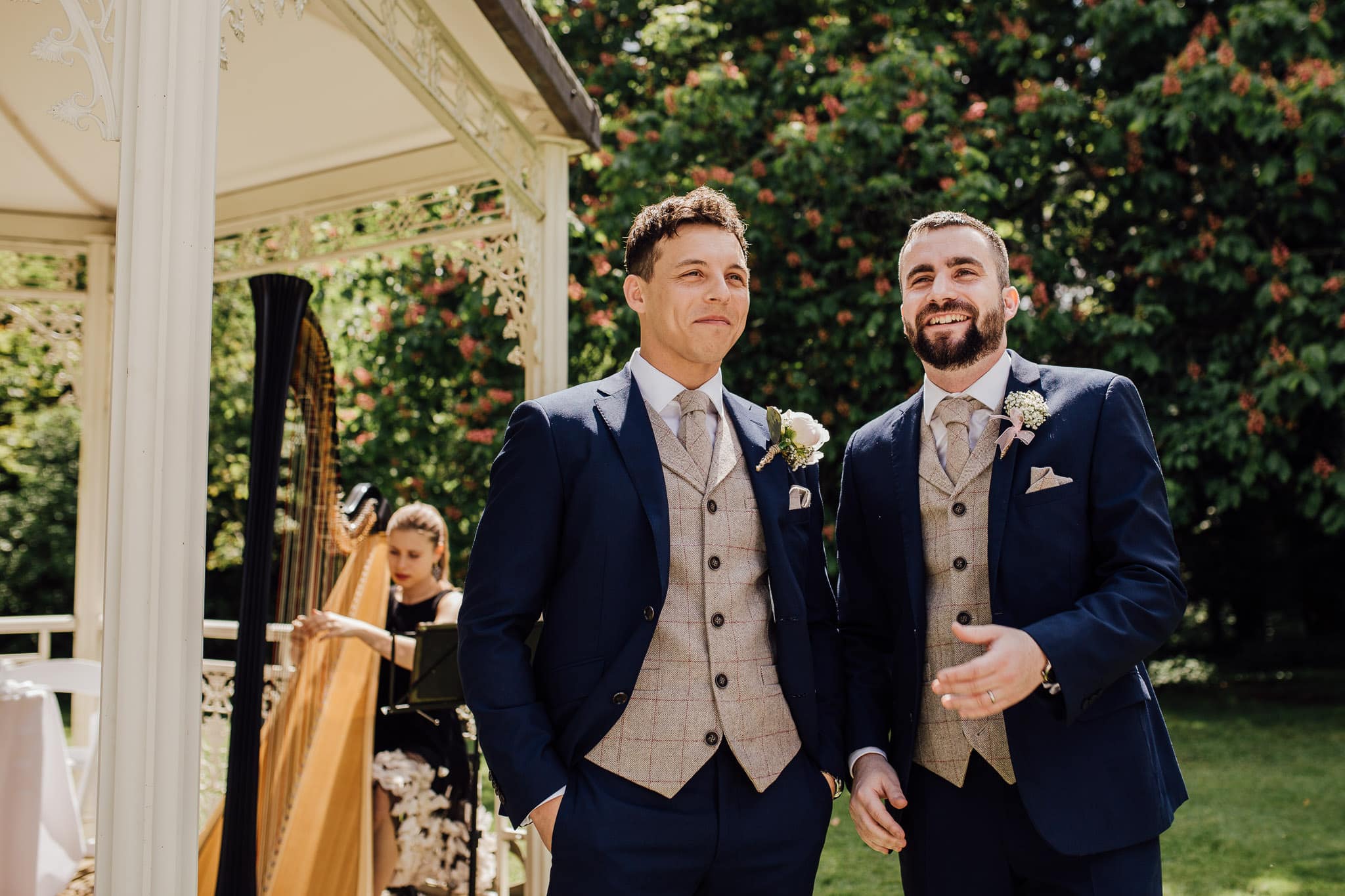 groom waits for his bride at garden ceremony