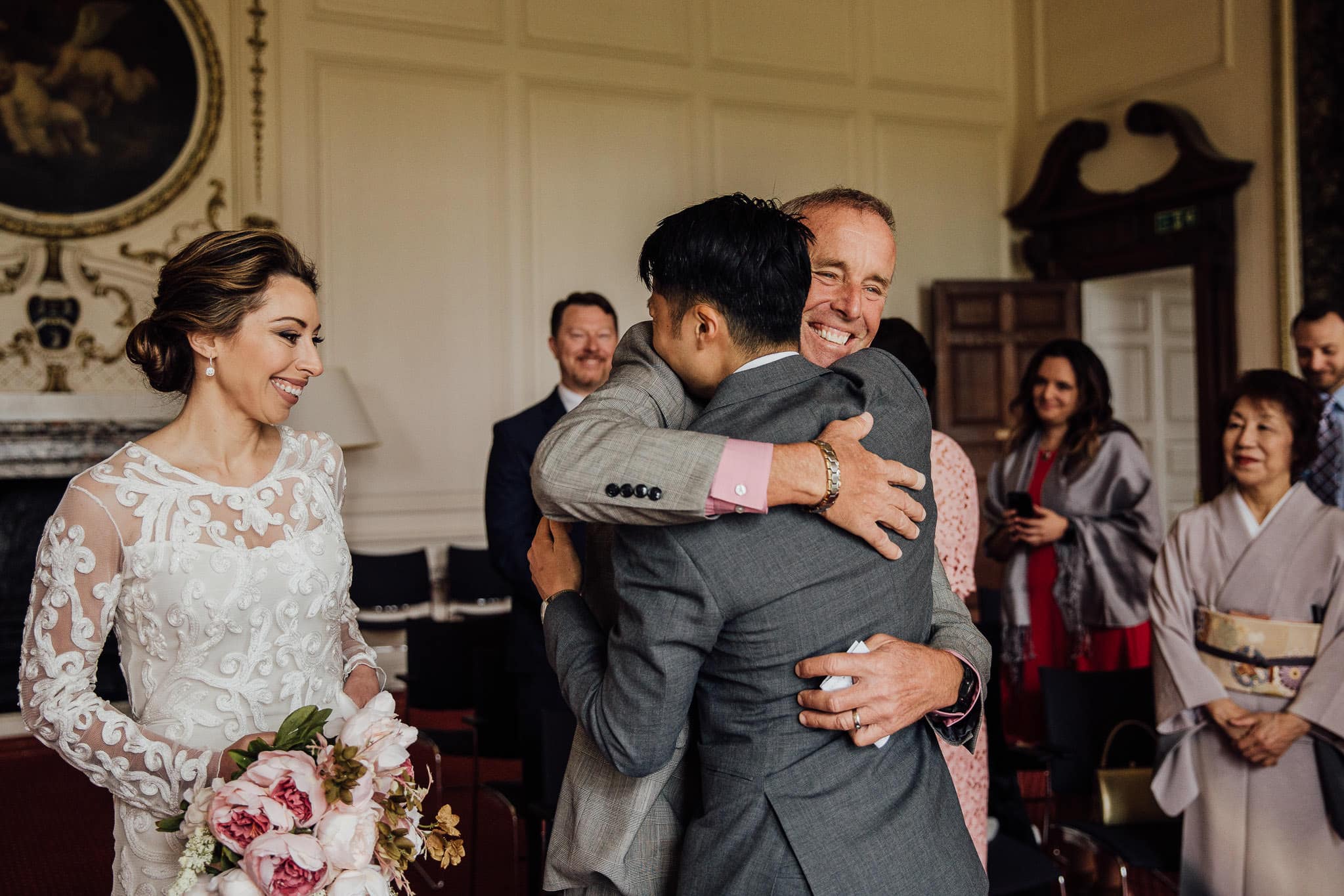 father of the bride giving groom a big hug