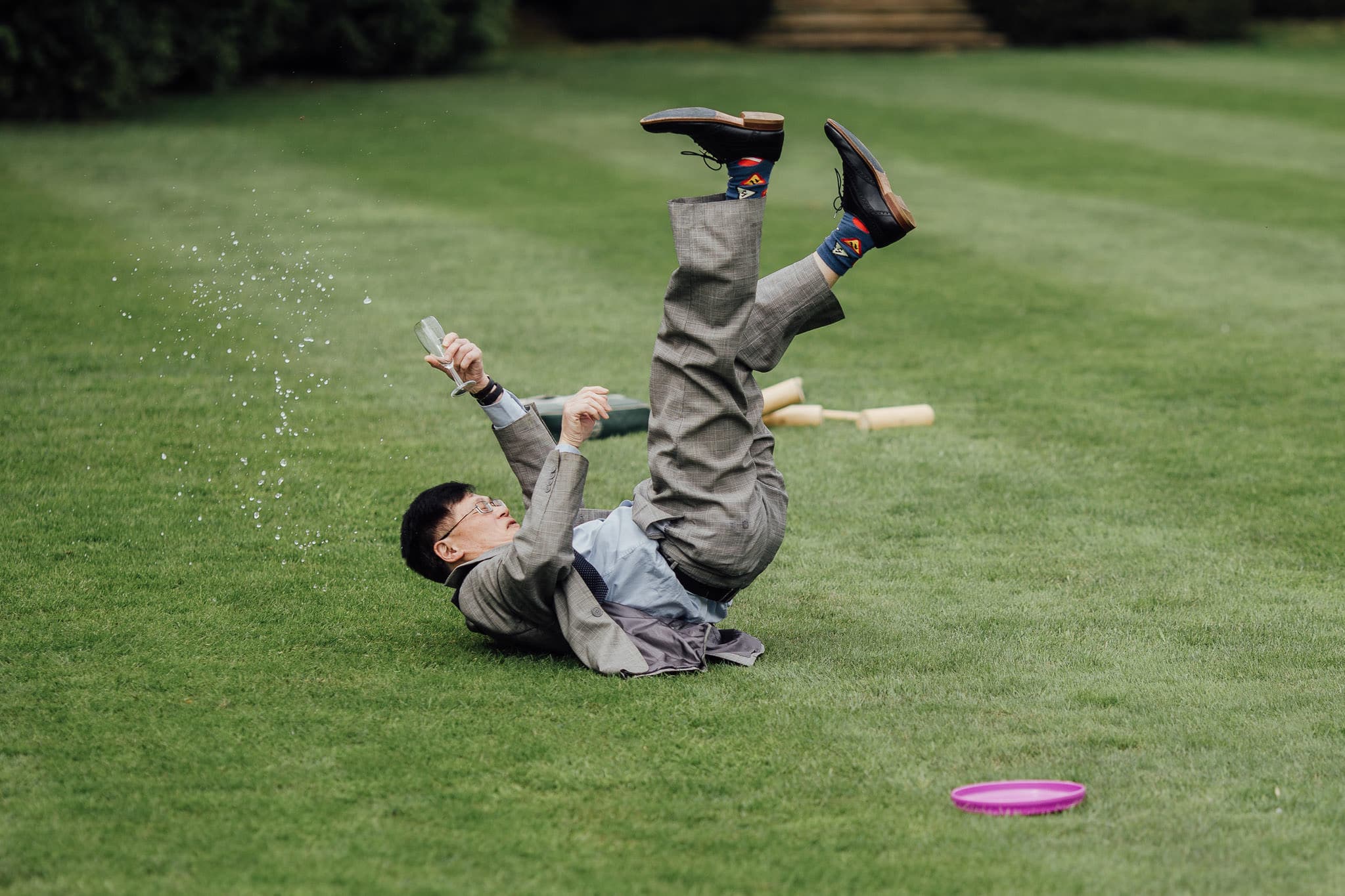 funny wedding photo of guest falling over