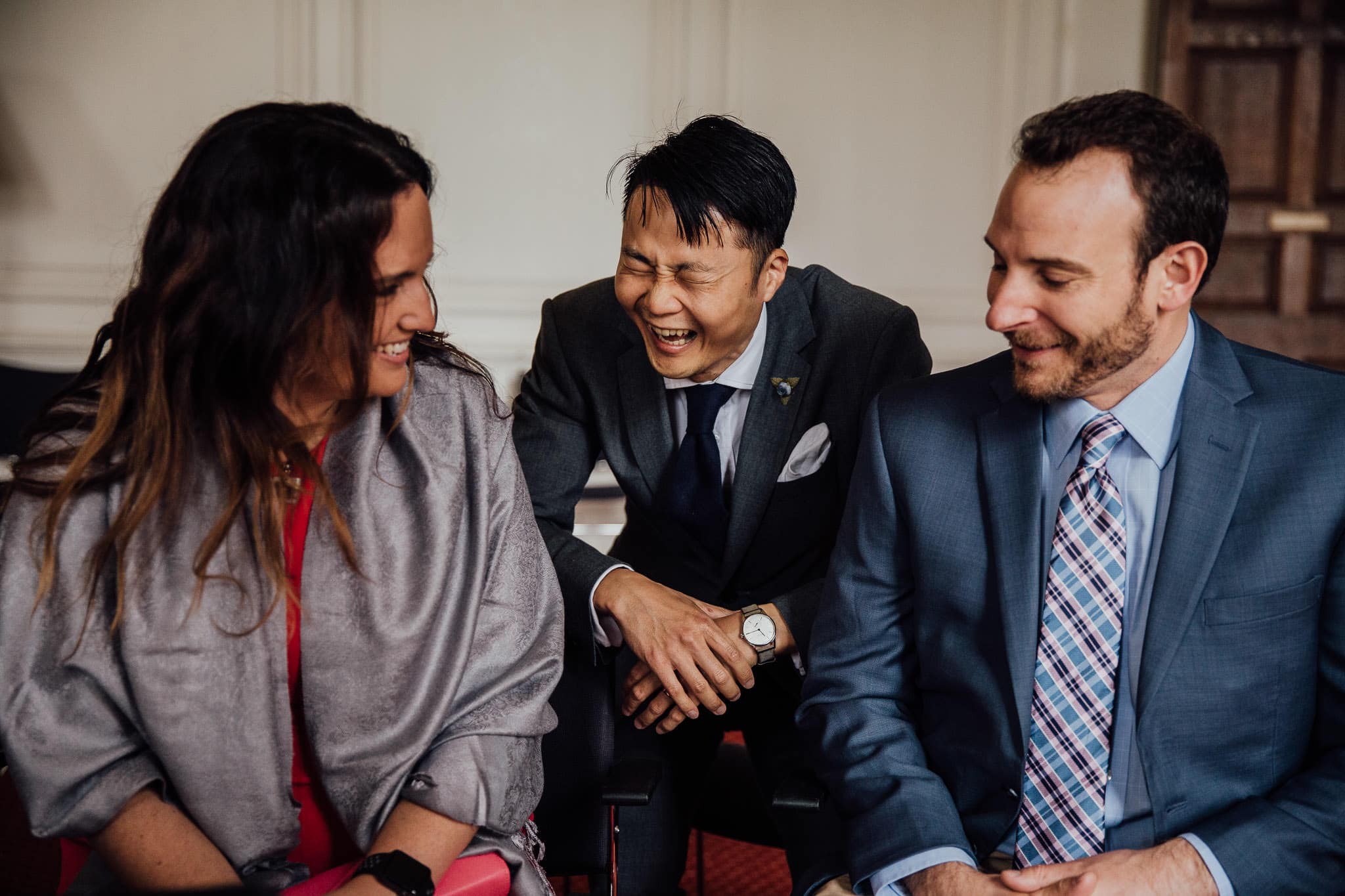 groom laughing with guests